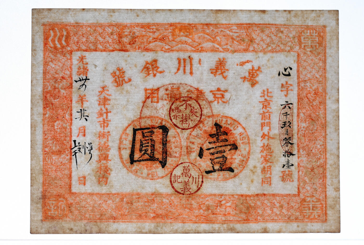 泓盛2025年秋季拍卖会 纸币 光绪年·天津万义川银号京津通用壹圆，棉纸版，上印双龙及旭日波浪等图，背盖四君子诗文吉语圆戳，少见，纸张纹理清晰，凹凸强烈，色彩浓郁醇厚，原汁原味，九八成新