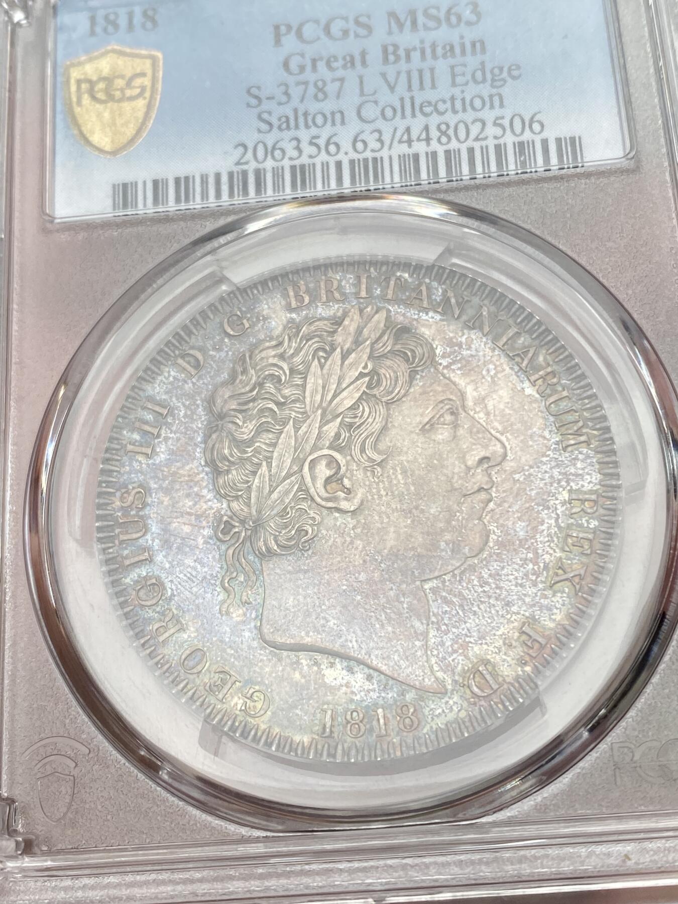 万国钱币拍卖第053期【万国秋季大拍上●周五周六两场连拍】 PCGS MS63 1818年英国乔治三世马剑克朗 英国马剑系列首年开山之作 打制锋利初铸感极强 类镜面质感的底板在英系渐变五彩的加持下绝对称得上是视觉享受 Salton名家旧藏 国际市场涨幅非常明显的品种