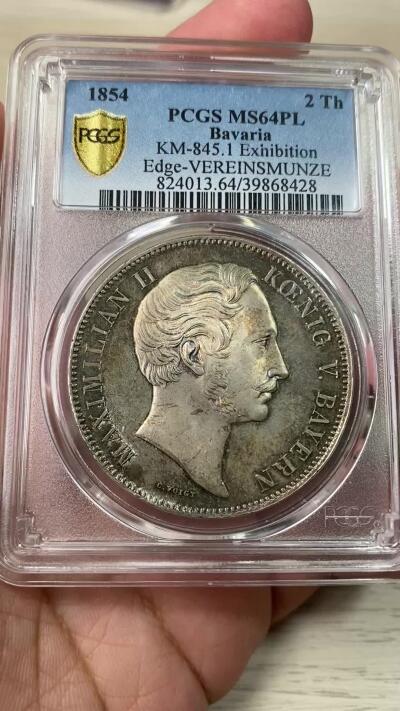 万国钱币拍卖第053期【万国秋季大拍下●周五周六两场连拍】 PCGS MS64PL 1854年巴伐利亚马克西米利安二世水晶宫历史2泰勒 相较尺寸独树一帜的路一历史2T 规格回归流通2T的马二历史系列 水晶宫绝对是其中绕不开的品种 绚丽七彩包浆覆盖其深度类镜面质感的底板  所见最美 PC唯一冠军分
