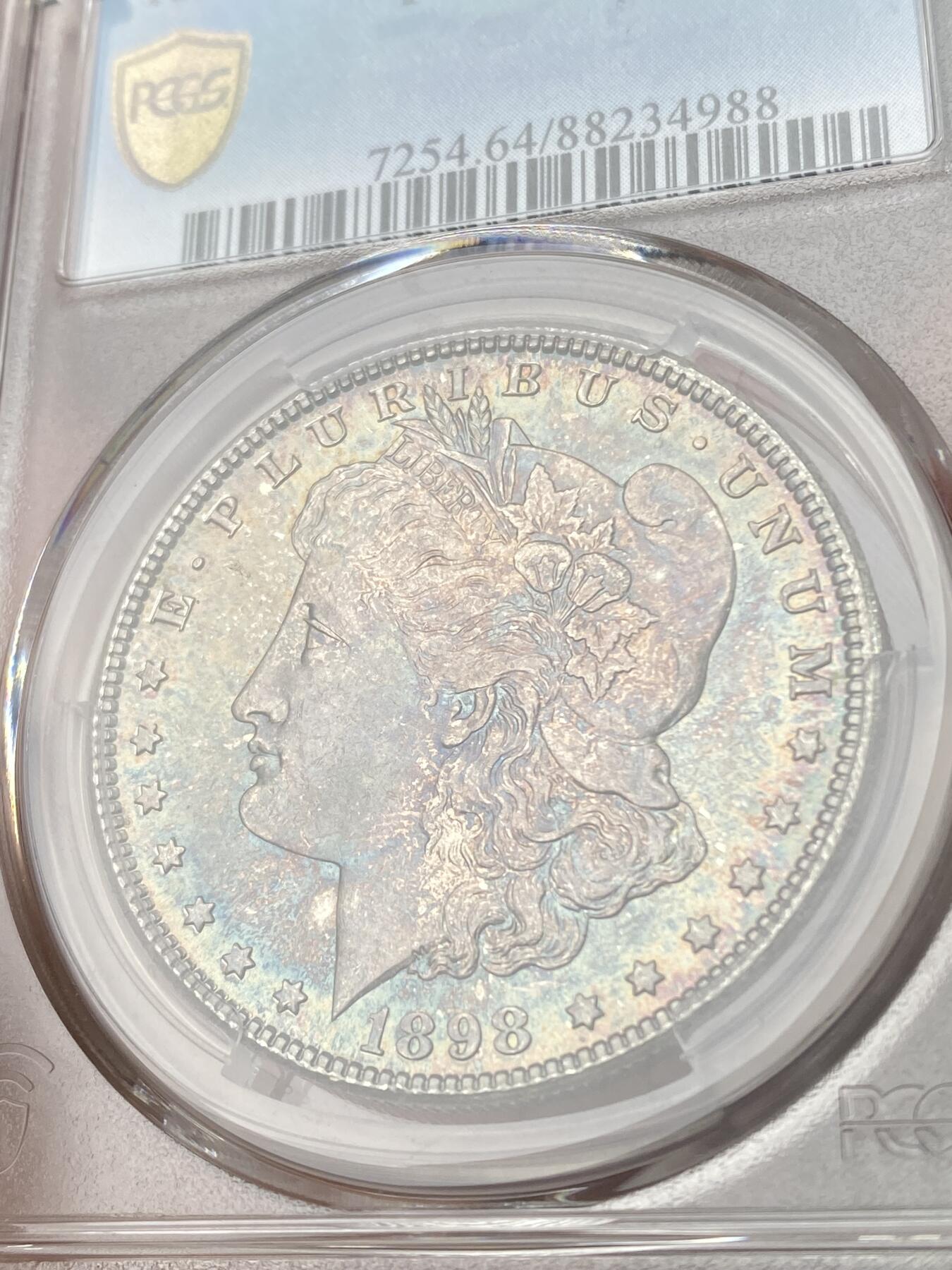 万国钱币拍卖第053期【万国秋季大拍下●周五周六两场连拍】 PCGS MS64 1898年O版美国摩根一元银币 丝滑转光 孔雀绿包浆全覆盖
