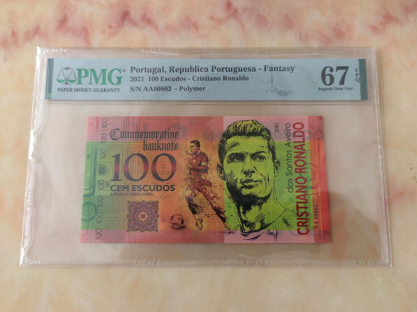 【礼羽收藏】🌏世界钱币拍卖第108期 全新PMG67E 2021年 葡萄牙 100埃斯库多 C罗 塑料纪念评级钞 首发AA冠全偶号 