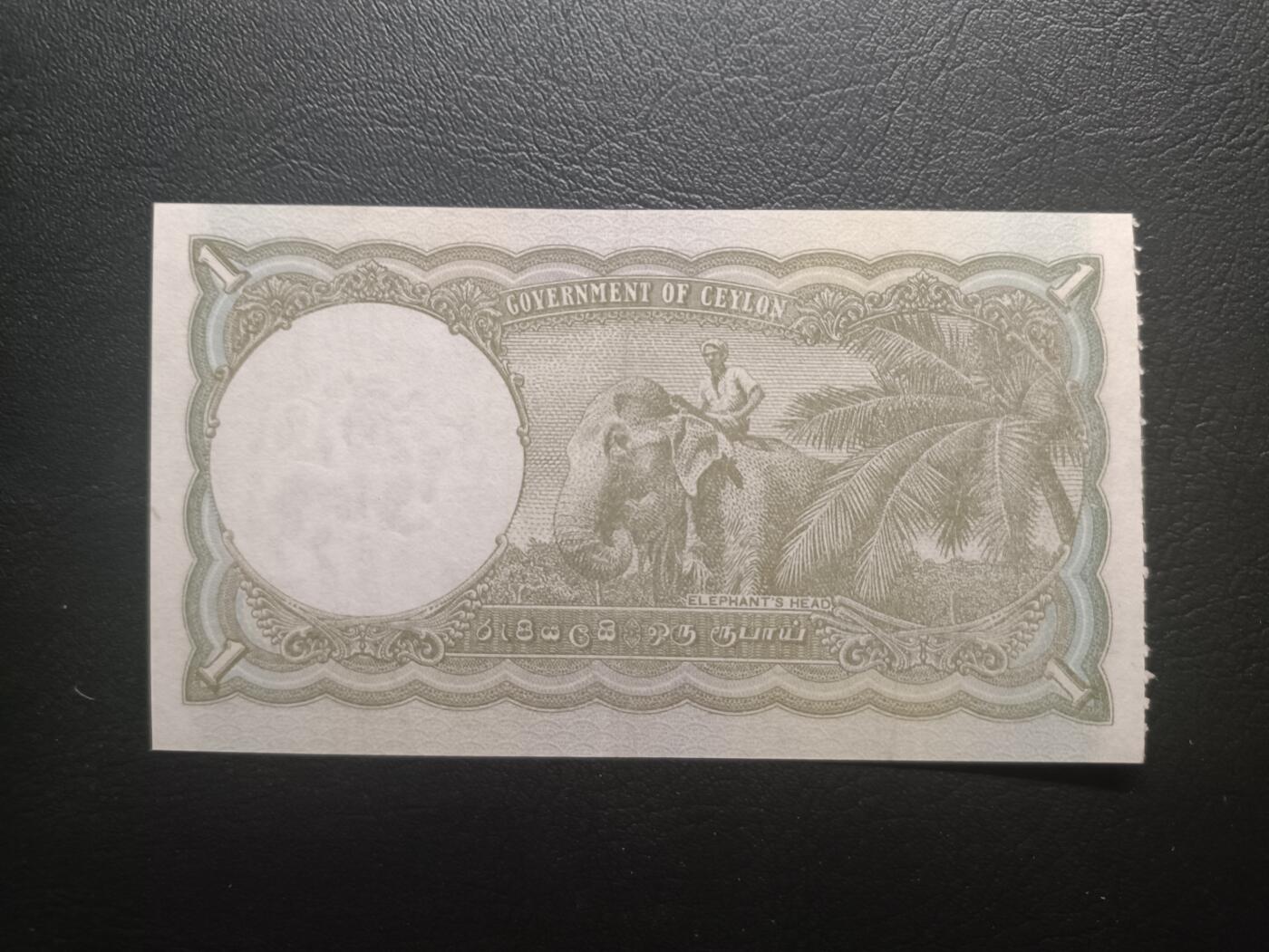 2025十一月第一期，总199期 英属锡兰（现斯里兰卡）1949年1卢比AUNC，乔治六世国王和骑大象，少见英属殖民地品种，特色是一侧有类似门票的齿孔