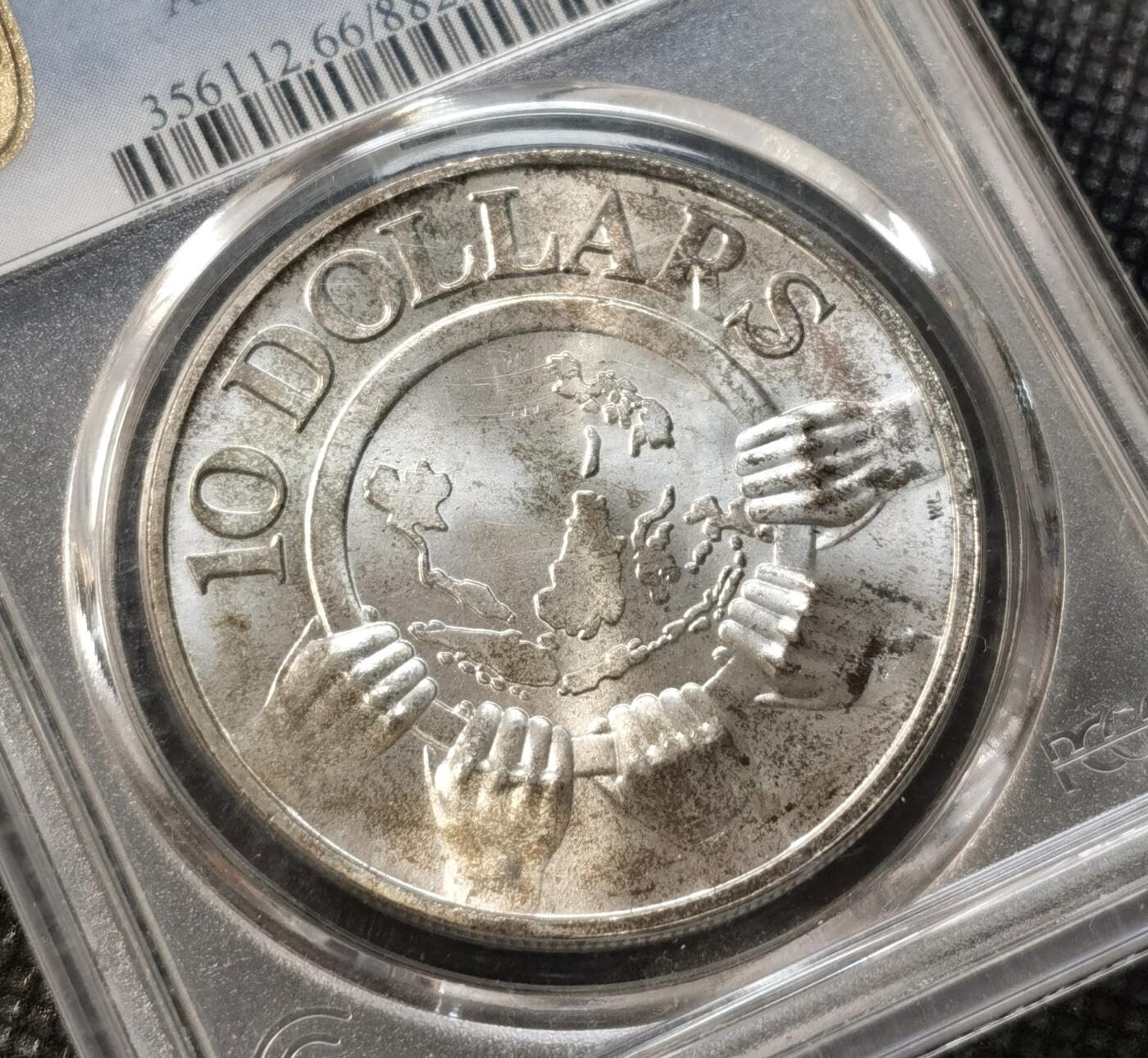 甄臻铺-世界币章拍卖（第37期），送拍享返佣金等优惠多多 PCGS-MS66 新加坡1977年10元精制银币 转光 1967-1977纪念东盟成立10周年
