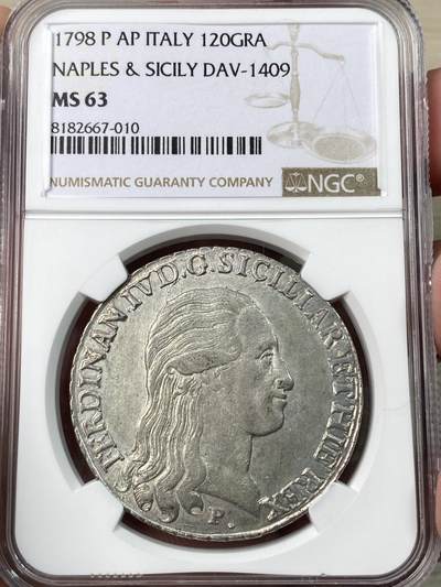万国钱币拍卖第054期 - NGC MS63 意大利1798年西西里那不勒斯王国120G大银币 无可挑剔的状态，灯光下银光闪闪。正面头发细节包括背面的盾徽打制极佳，在63中这样的状态也很难得。23年kunker同分成交价约合人民币9000元。
