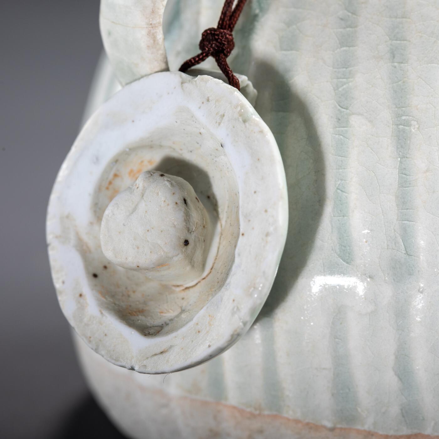 日本大阪雅和auction 2025金秋競賣會第一期 宋 湖田窯執壺 尺寸:W:11 H:9cm 備註:盒付   本器為宋代湖田窯所製執壺，通體施青白釉，釉色清潤柔和，溫潤如玉。壺身與蓋飾以螺旋剔刻紋，刀工流暢，層次分明，體現極高工藝水準。壺形端正，流口、把手與蓋鈕比例協調，實用與美觀兼具。此壺保存完好，為古瓷愛好者與茶道收藏者不可多得之佳品。