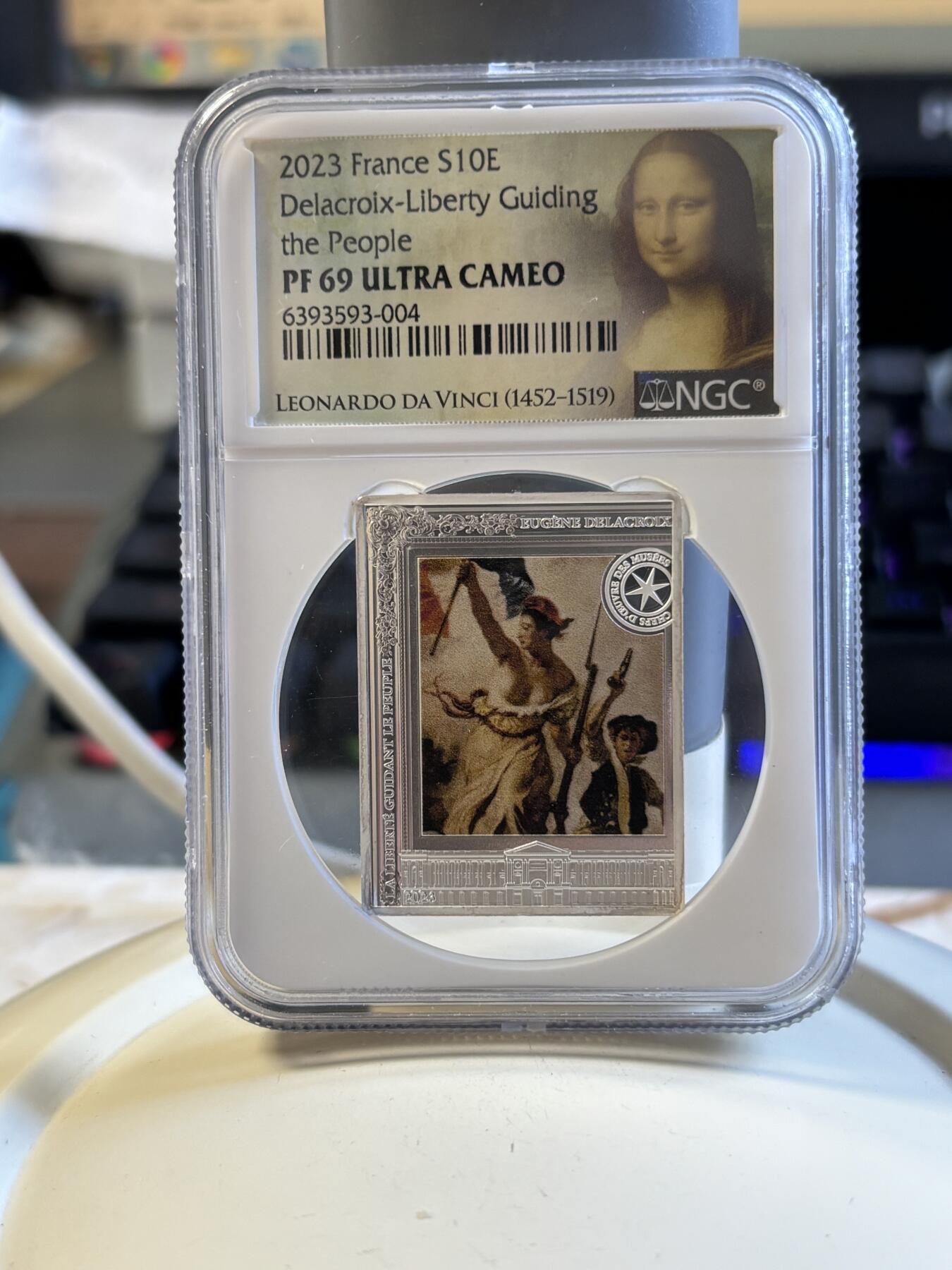 第181期拍卖  2023年法国10欧精制纪念彩色银币 自由指引人民NGC PF69 特殊蒙娜丽莎标，999银，22.2克
