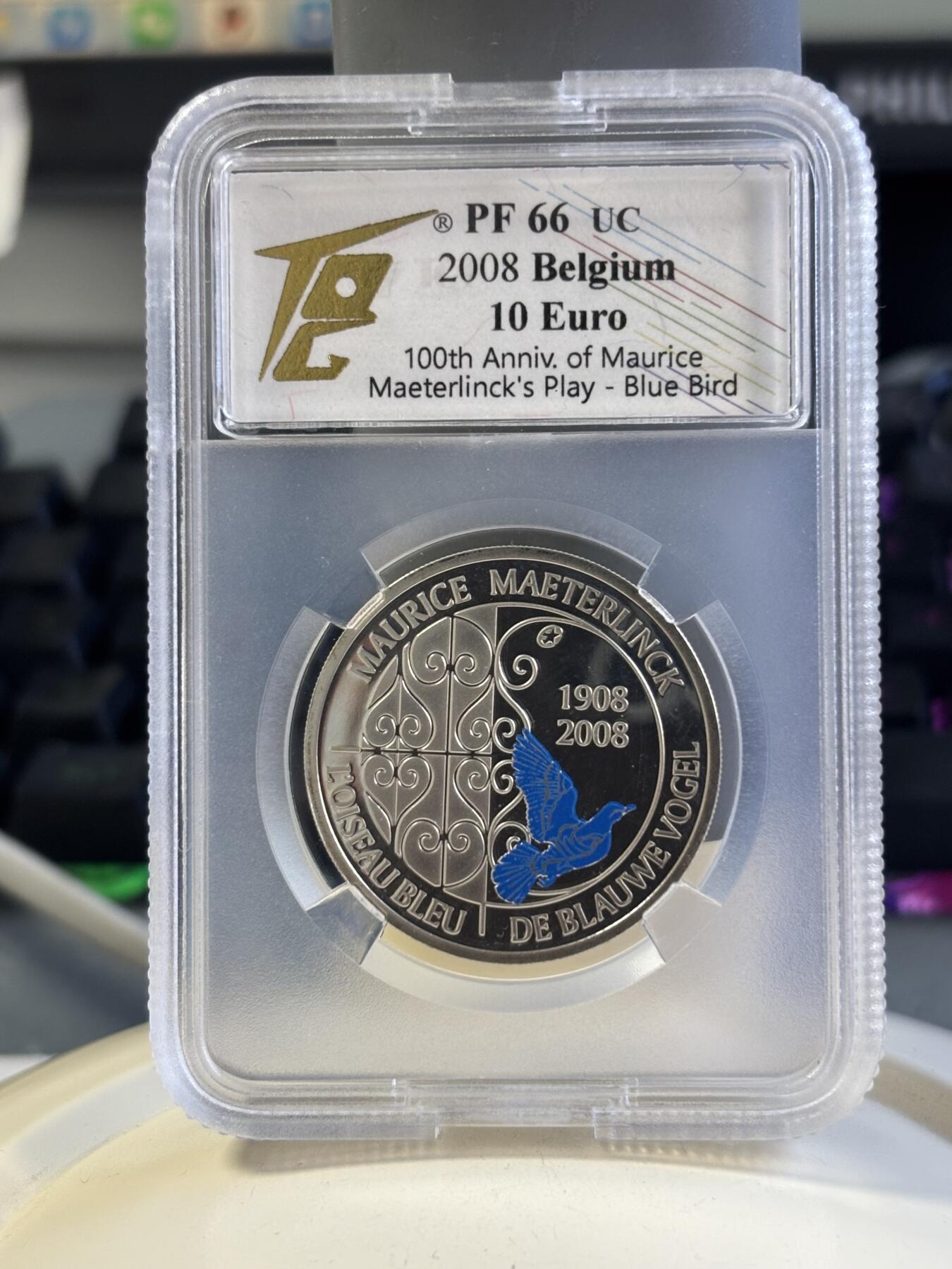第181期拍卖 比利时2008年欧洲之星系列-莫里斯·梅特林克戏剧《蓝色小镇》上演100周年（蓝鸟）10欧局部彩色精制银币TQG PF66UC  925银 18.75克 发行量：约2万枚 