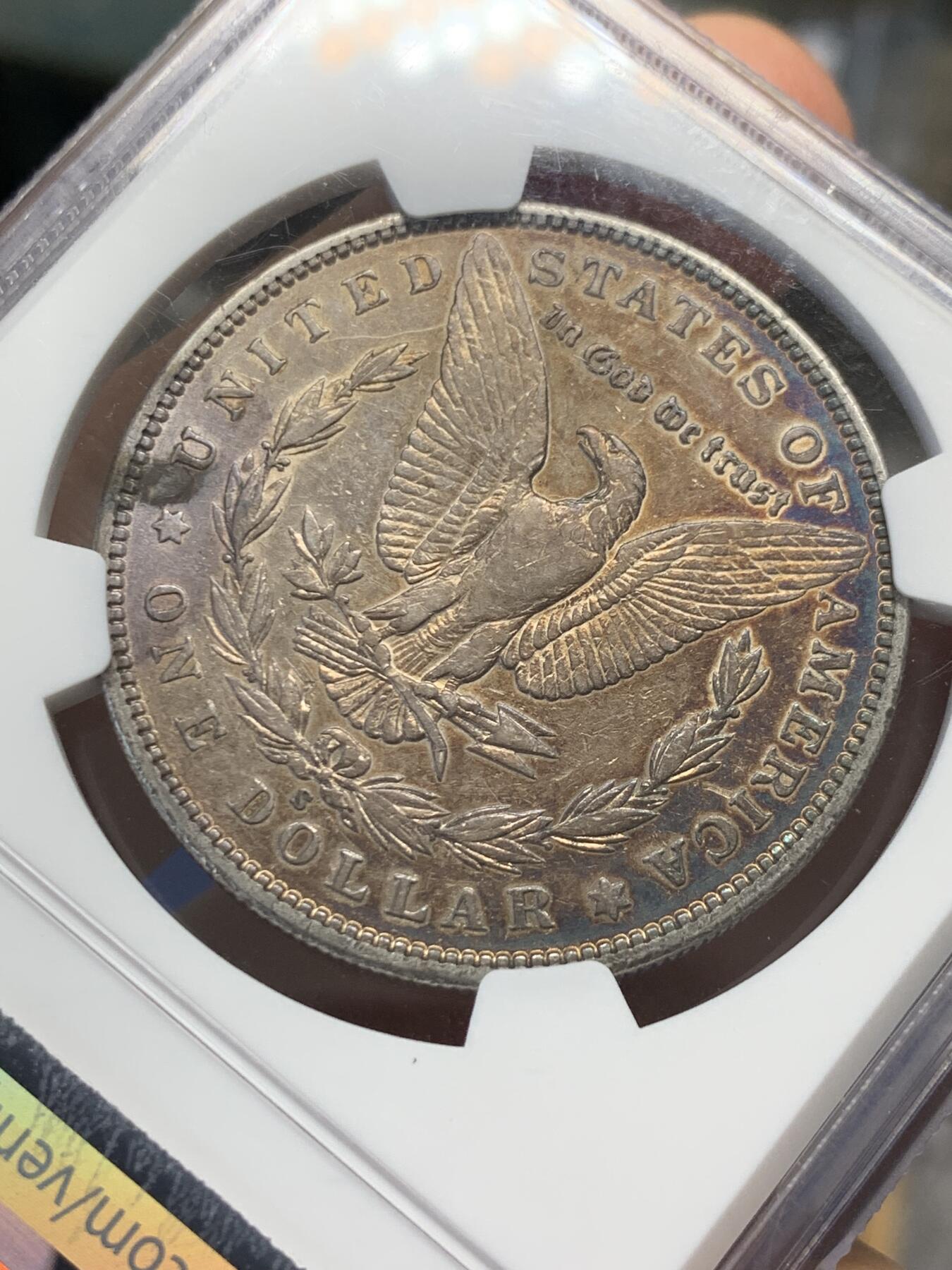 《竞宝斋》第436场 周日，周一2场连拍 （全场包邮） NGC AUD 美国1899年摩根银币S厂 少见摩根，1899年最便宜的是O厂，其次是P厂，最贵S厂， 63分白币指导价800刀，该枚橙金彩，两面深蓝月牙彩。