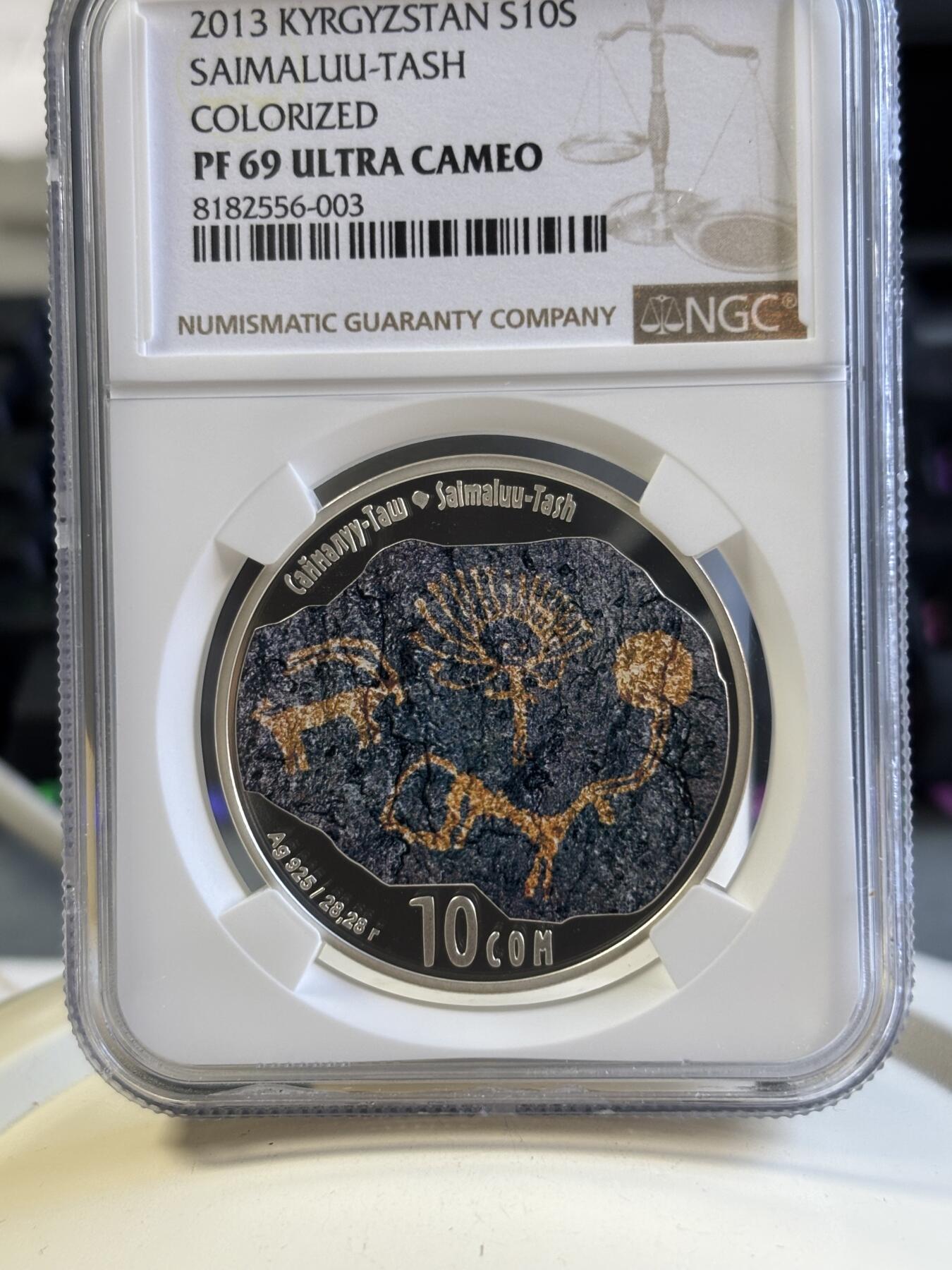 第181期拍卖 吉尔吉斯斯坦 2013年 岩石画群古迹彩色精制纪念银币（获奖币）NGC-PF69,28.28克，925银