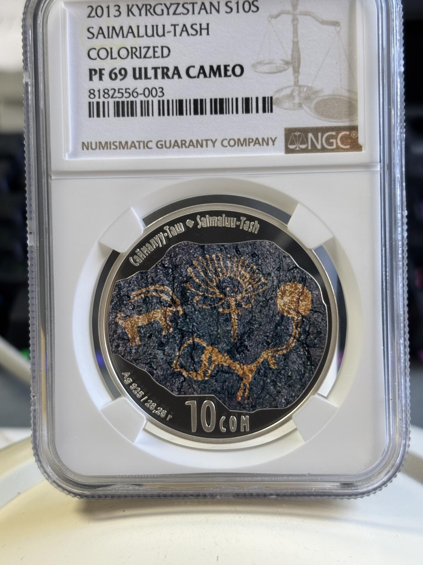 第181期拍卖 吉尔吉斯斯坦 2013年 岩石画群古迹彩色精制纪念银币（获奖币）NGC-PF69,28.28克，925银