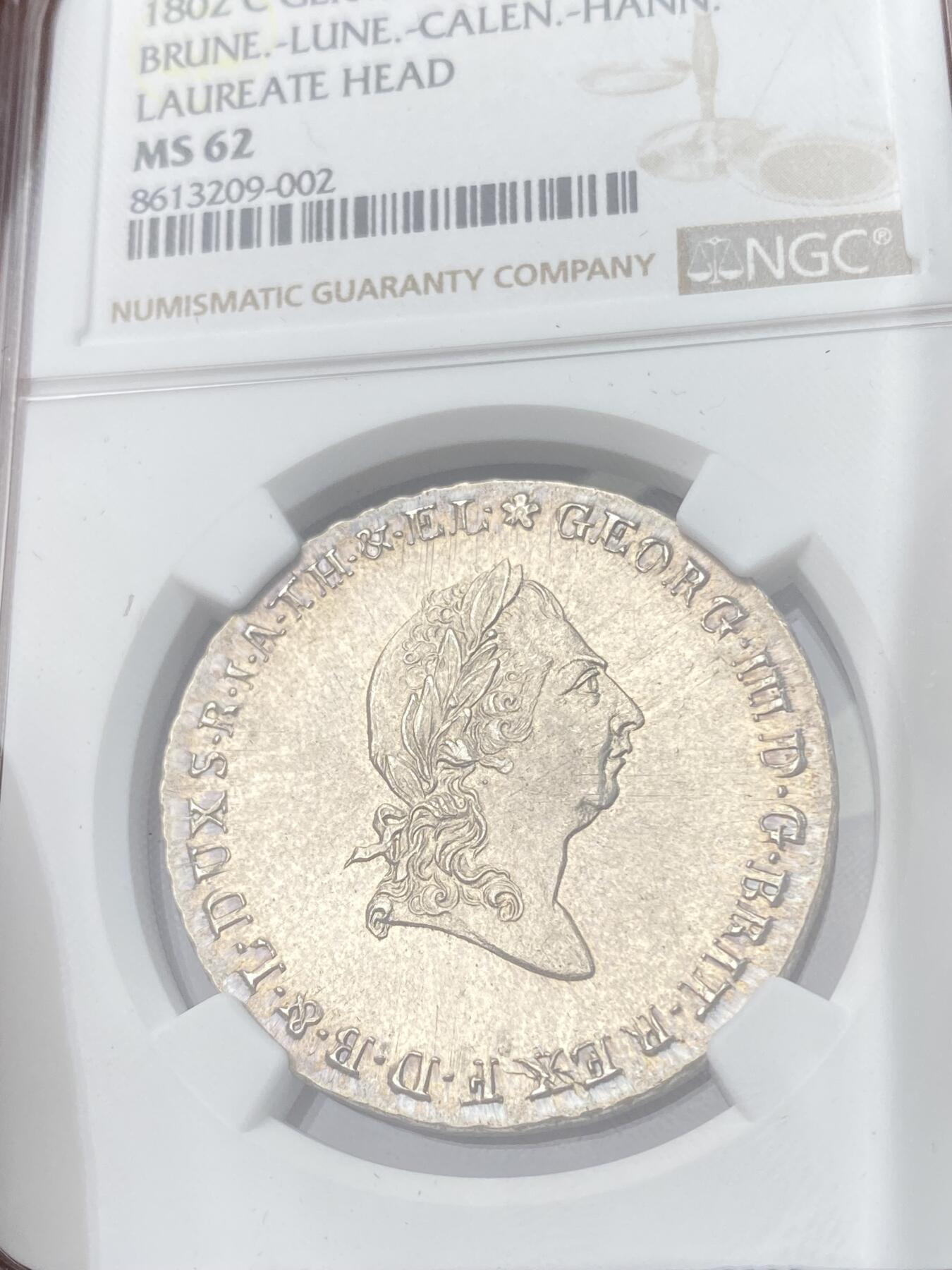 万国钱币拍卖第055期 NGC MS62 1802年英国共主德国布伦瑞克-吕讷堡-卡伦堡-汉诺威乔治三世2/3泰勒大银币 除了有强烈的喷砂感外高点也近乎完美 淡金色环彩非常漂亮