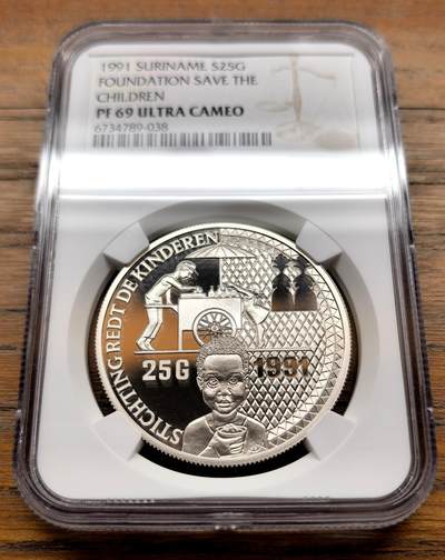 泉海漫舟·凡希社世界钱币微拍第三百十四期 - 1991苏里南保护儿童基金会纪念25G大银NGC-PF69UC