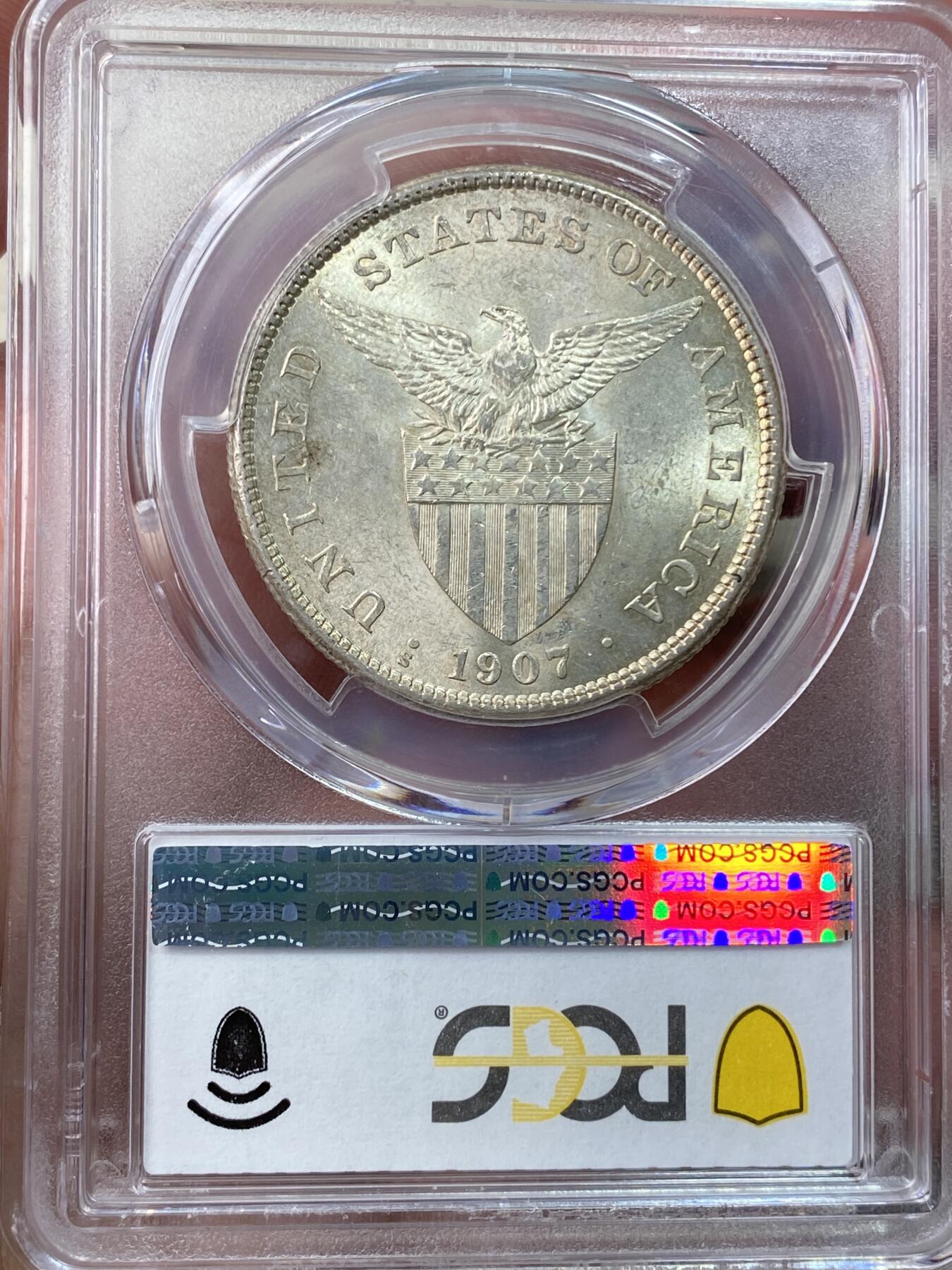 万国钱币拍卖第055期 PCGS MS62 1907年美属菲律宾火山女神1比索大银 十字黄油转光非常耀眼