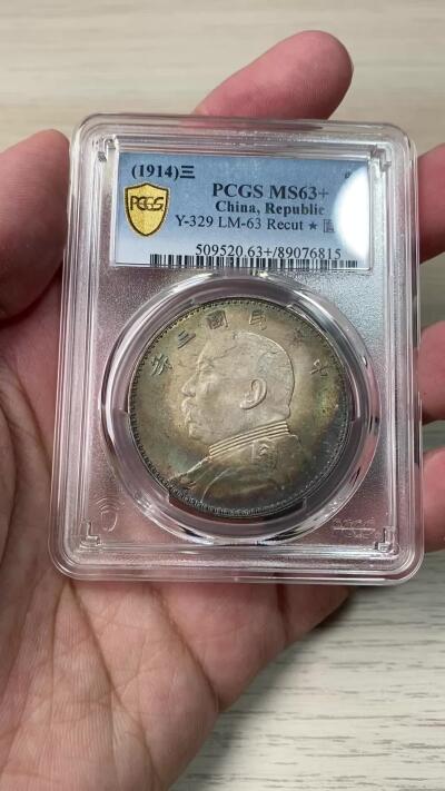 万国钱币拍卖第055期 PCGS MS63+ 1914年民国三年袁像一元 三角元版本 丝绸粉光与百年月牙孔雀绿酱彩交汇 一眼入魂的顶级收藏品质