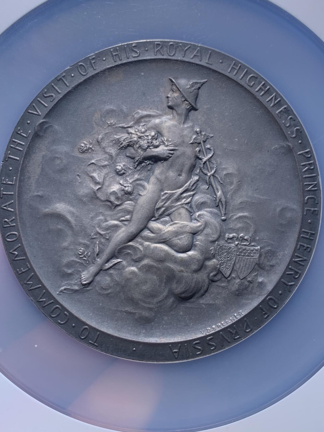 《竞宝斋》第438场 周日，周一，周二 3场连拍 （全场包邮） NGC MS64 美国1902年纪念德国普鲁士王子访问纪念大银章。尺寸69.7MM，拿在手里沉甸甸。正面为中老年身穿戎装的普鲁士王子，背面为代表商业繁荣的墨丘利身处云层中看向西方。在背面的右下角还有代表美国的盾徽和普鲁士的鹰徽连在一起。不管是王子人像面还是墨丘利面都雕刻的极其繁复。发行量301枚，matte工艺，入盒首见。