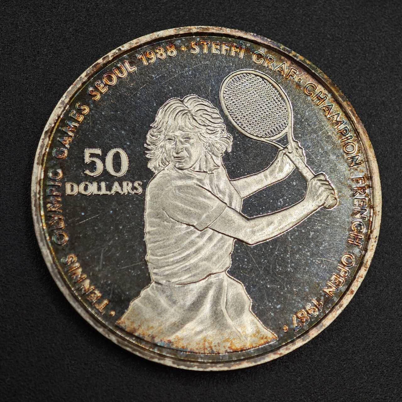 【淘币小摊】实时拍第七百九十九拍   银币套币场   满百包邮可预留二周 每周一统一发货   纽埃1987年50元网球纪念银币彩色包浆 重27.1克625银 银价195