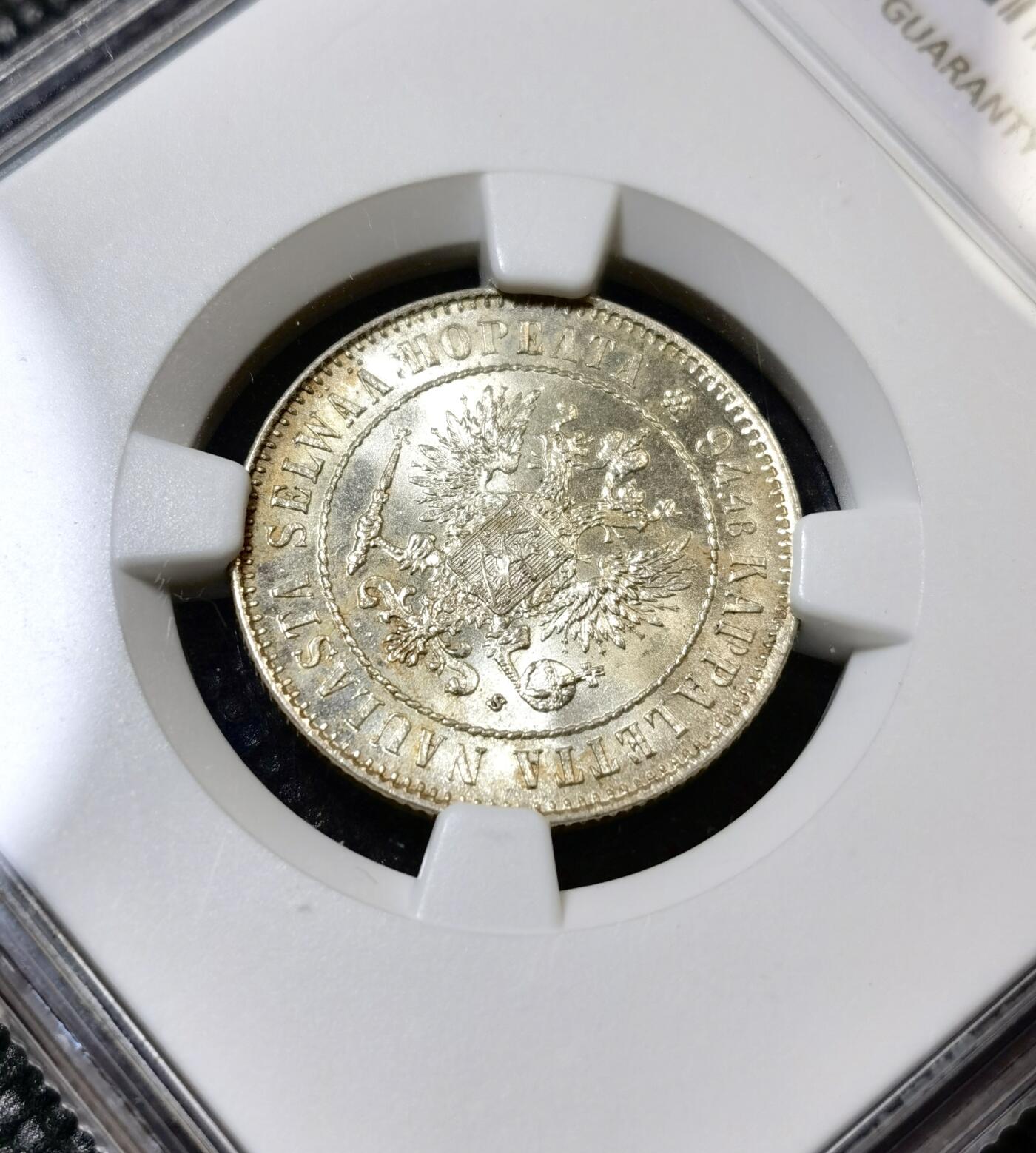 甄臻铺-世界币章拍卖（第40期）送拍享返佣金等优惠多多 NGC-UNC 1915年俄占芬兰1马克银币，因为表面粘了别的锈迹，给了stained，底板非常好，转光强烈，清理可达ms64左右的分数