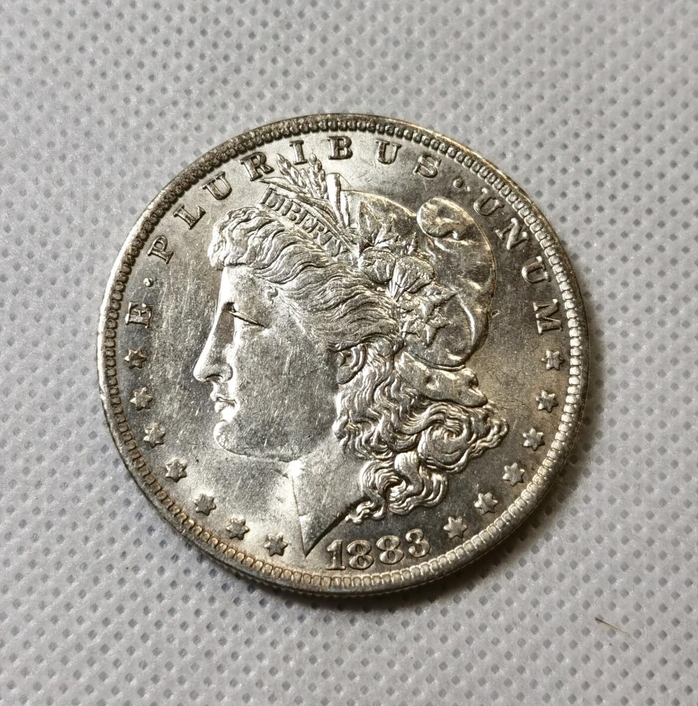 甄臻铺-世界币章拍卖（第40期）送拍享返佣金等优惠多多 UNC美国1883奥尔良厂摩根一美元银币，转光品相好，非常不错的状态，细节见图