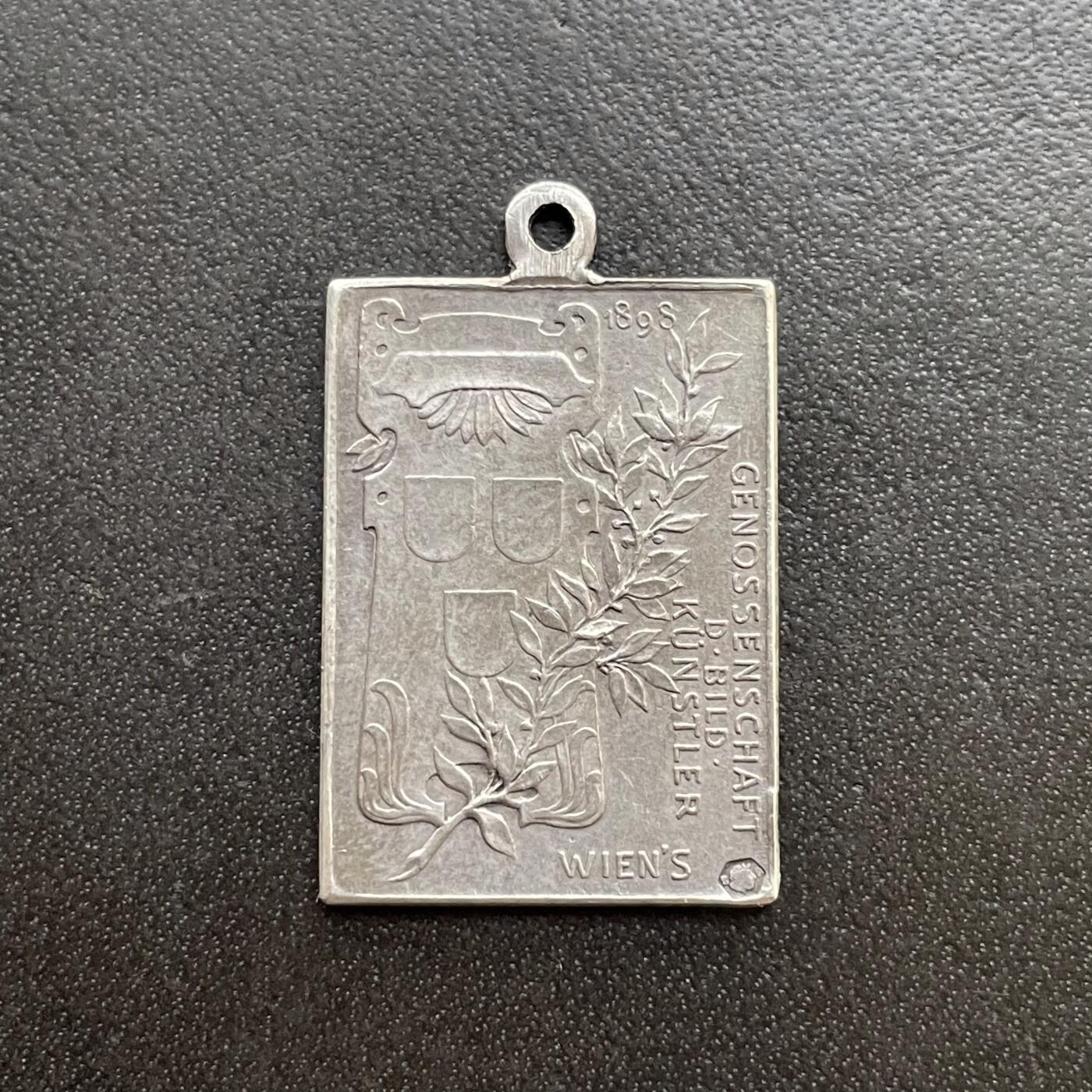 「木头集藏」章牌精品专场！    Anton Scharff～1898年奥地利弗朗茨皇帝在位50周年纪念银章 ，尺寸：23×16mm，3.6g，雕刻大师安东·沙夫非常罕见的一款作品。尺幅虽小但是银标和厂铭打得都很清晰。此章是奥地利美术家协会为纪念弗朗茨皇帝在位50周年而特别委托铸造。