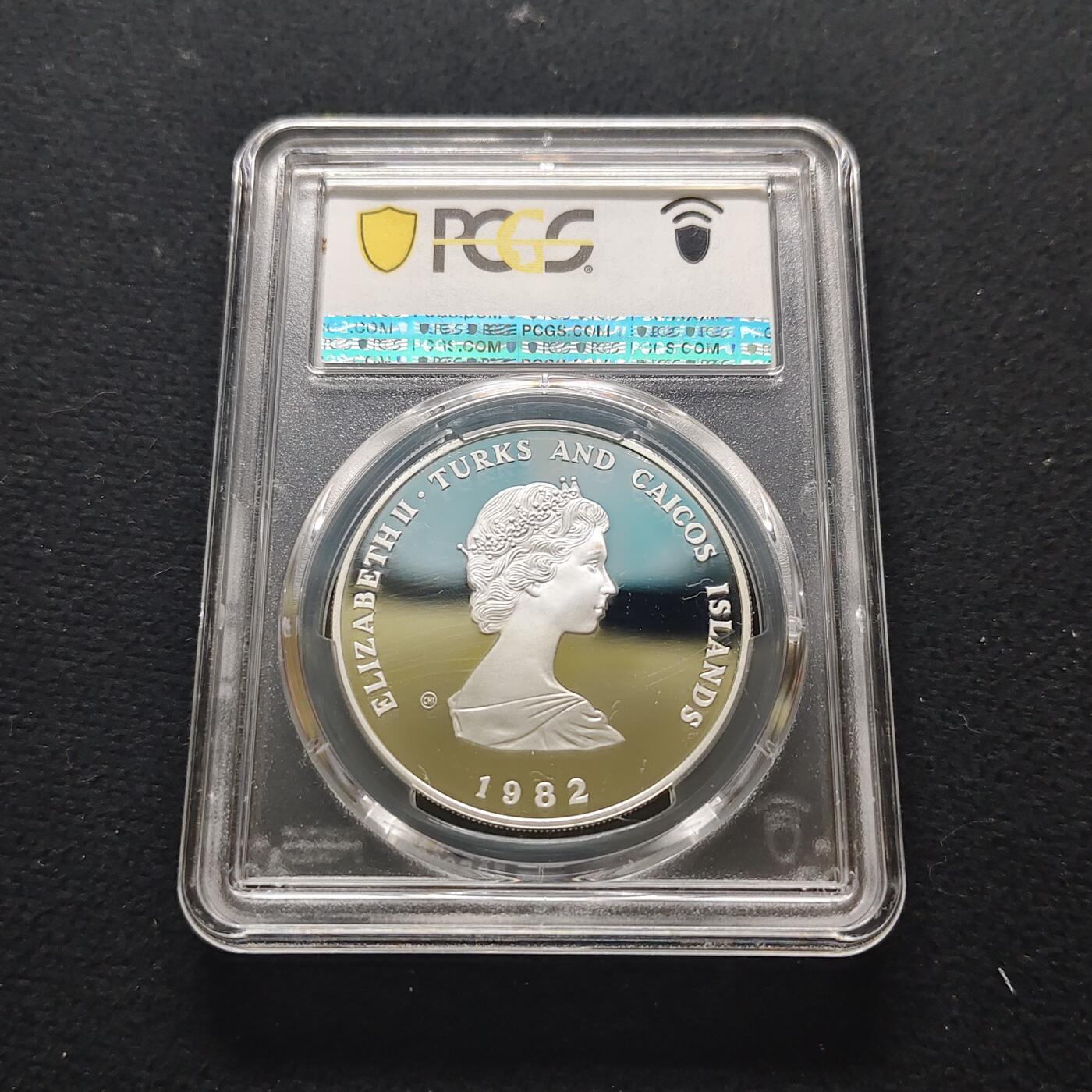 【全场包邮】纯粹捡漏拍481场（免费代拍第18场） 【少见】特克斯和凯克斯群岛1982年10克朗国际儿童年精制纪念银币-量7928-PCGS PR69 DCAM
