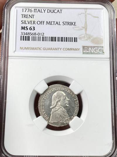 万国钱币拍卖第056期 - NGC MS63 意大利1776年特伦托主教区杜卡特银样币，正面为亲王教区主教彼得罗·维吉利奥，背面为特伦托教区徽章。特伦托地区最大面值银币，用金杜卡特模具铸造，用于赠送贵族名流而不是流通。钱币权威网站numista该品种封面币。欧洲同品种裸币成交价约5400人民币。