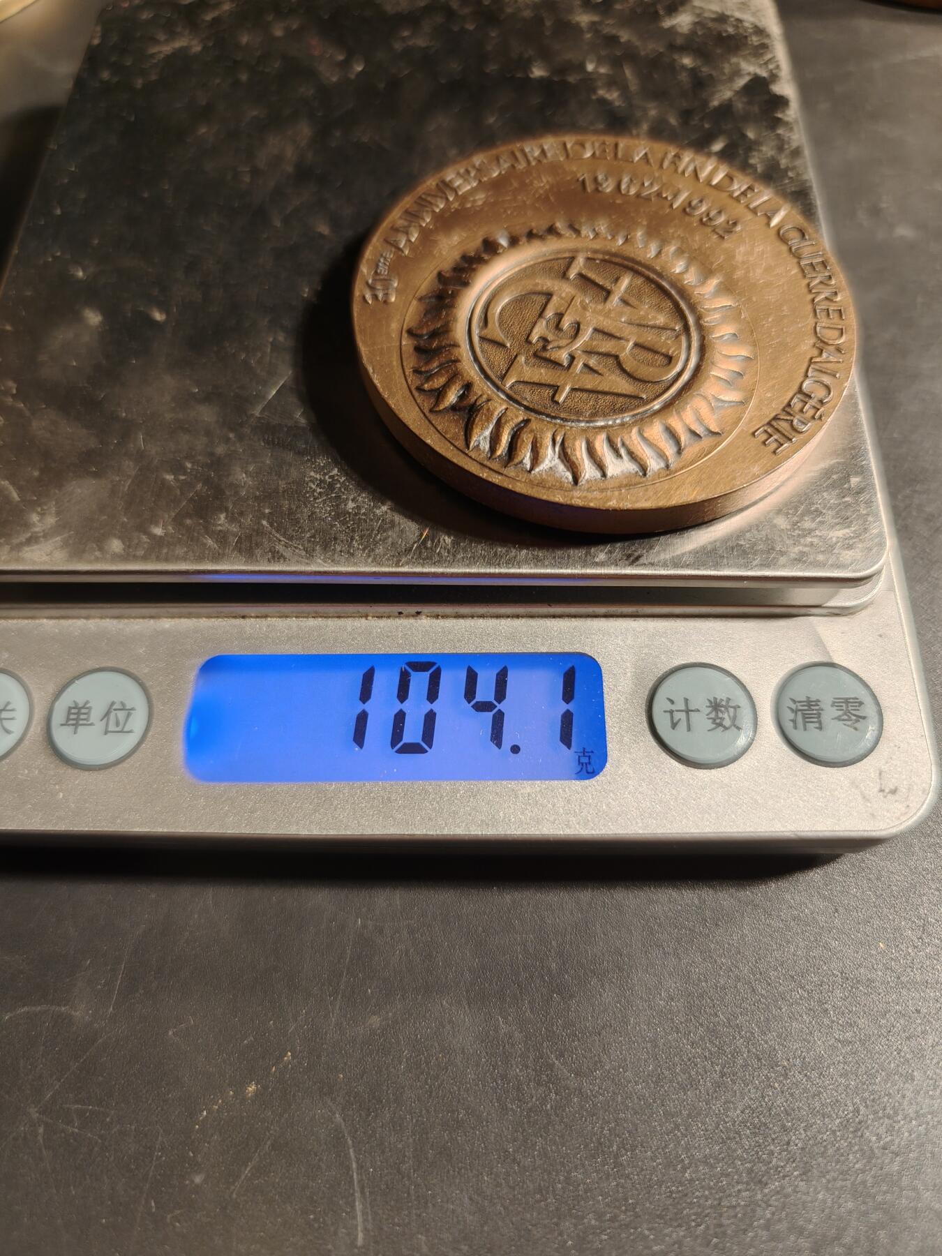 老王徽章第167期 法国退伍军人、战争受害者和战争之友协会阿尔及利亚战争30周年大铜章       高浮雕      正面描绘了和平鸽飞越被战争摧毁的城镇上空，背景是废墟和一片墓地，象征着对战争的控诉和对和平的渴望      直径 54mm.     重量104.1g