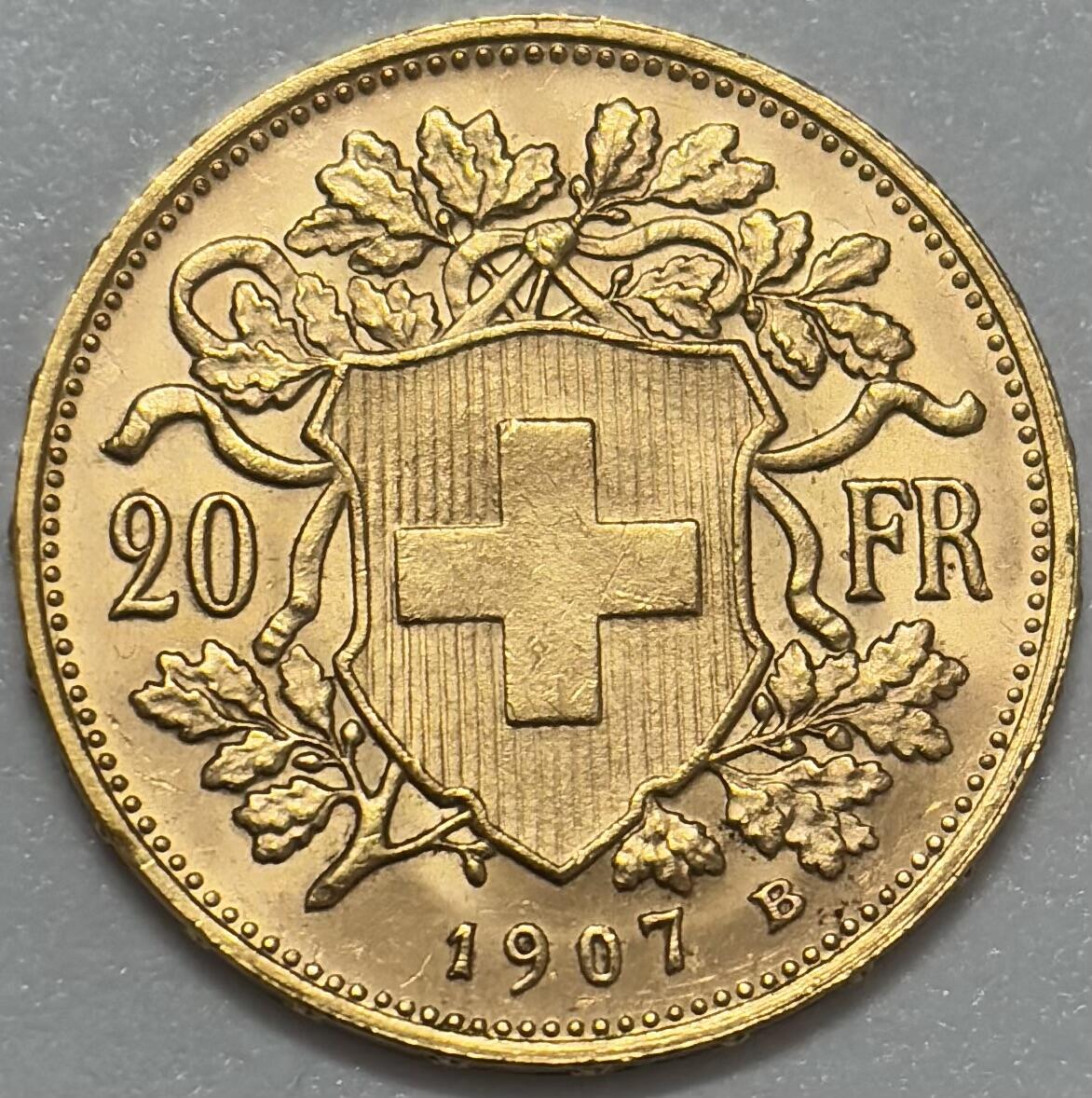 文馨钱币收藏第 283 场，【大雪鉴珍，寒英缀金】金银纪念币精品场，诚邀您的参与【长期接代拍品】 原光 1907 年瑞士雪山女神 20 法郎金币，重 6.4 克金 底板丝滑无比，金光闪闪，第二版 B 厂，品相实属不易的投资收藏品