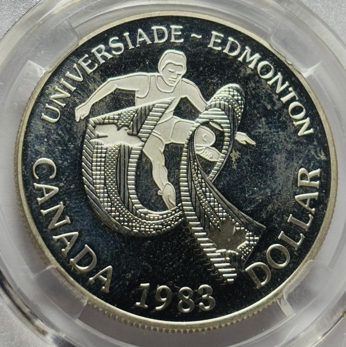 文馨钱币收藏第 283 场，【大雪鉴珍，寒英缀金】金银纪念币精品场，诚邀您的参与【长期接代拍品】 1983 年加拿大艾蒙顿大学运动会一元大银币，MS70 分