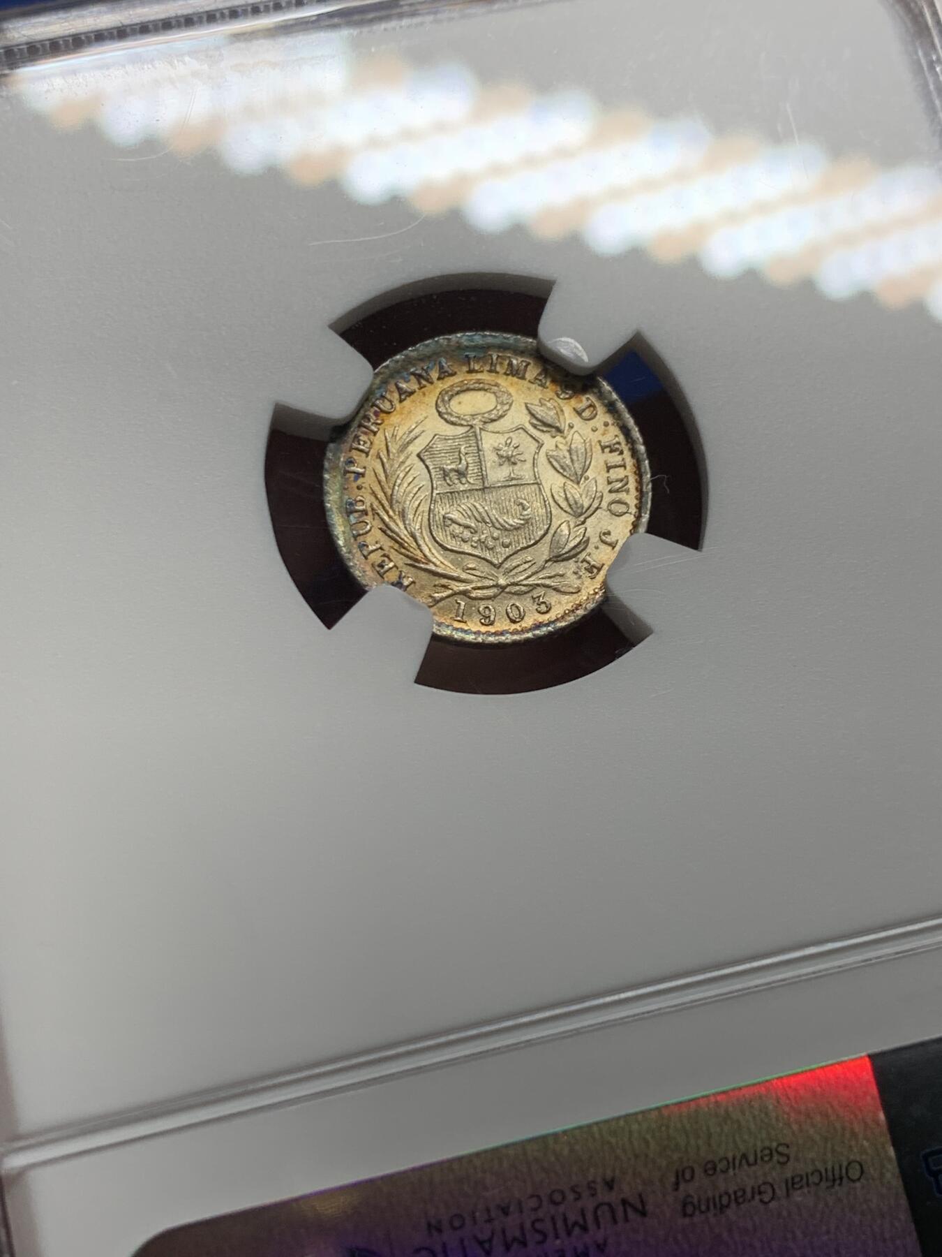 《竞宝斋》第444场 周日，周一，2场连拍 （全场包邮） NGC MS64 秘鲁1903年1/2蒂娜尔银币，双面带有月牙蓝彩包浆，十分亮眼的一枚，早期年份少见