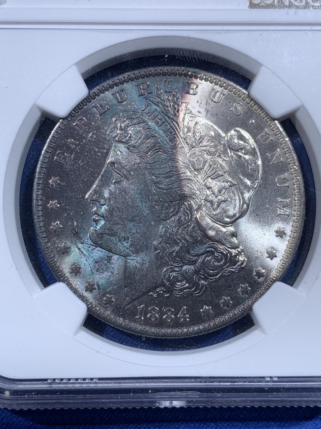 《竞宝斋》第444场 周日，周一，2场连拍 （全场包邮） NGC MS62 美国1884年摩根银币O版，原汁原味深蓝彩老包浆，极美大月牙彩，包浆醇厚润泽，状态极佳，低评。