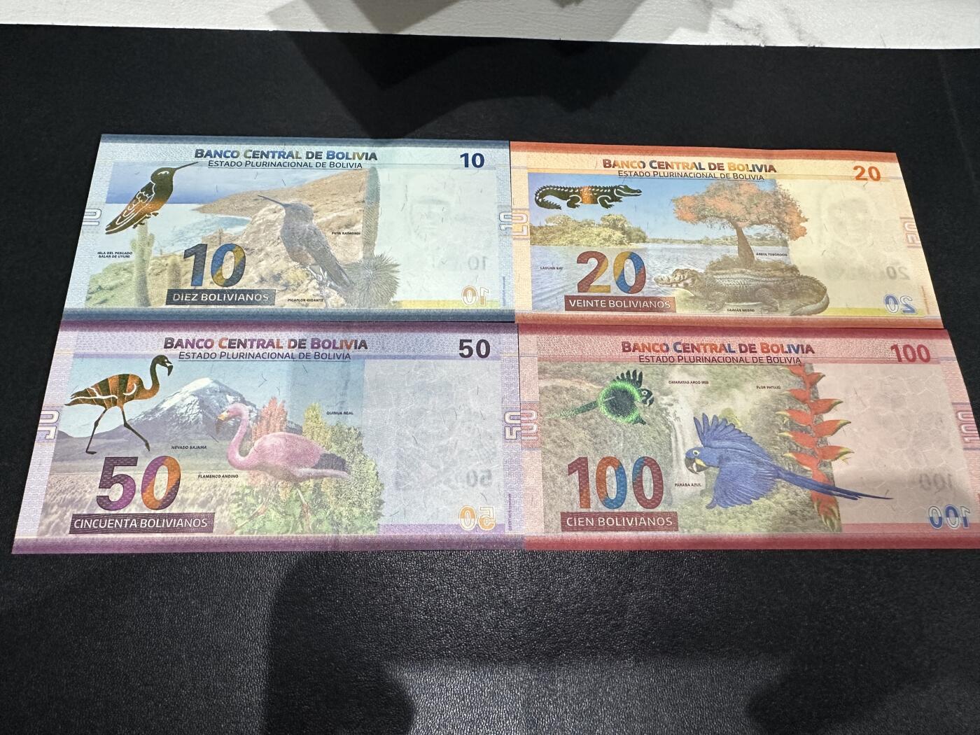 《外钞收藏家》第五百九十期（欧洲强钞、港币、硬通货及丰富裸币大拍场）（本平台长期征集拍品、欢迎藏友们联系合作） 玻利维亚10-100面额 4张一起 全新UNC 全部是尾8