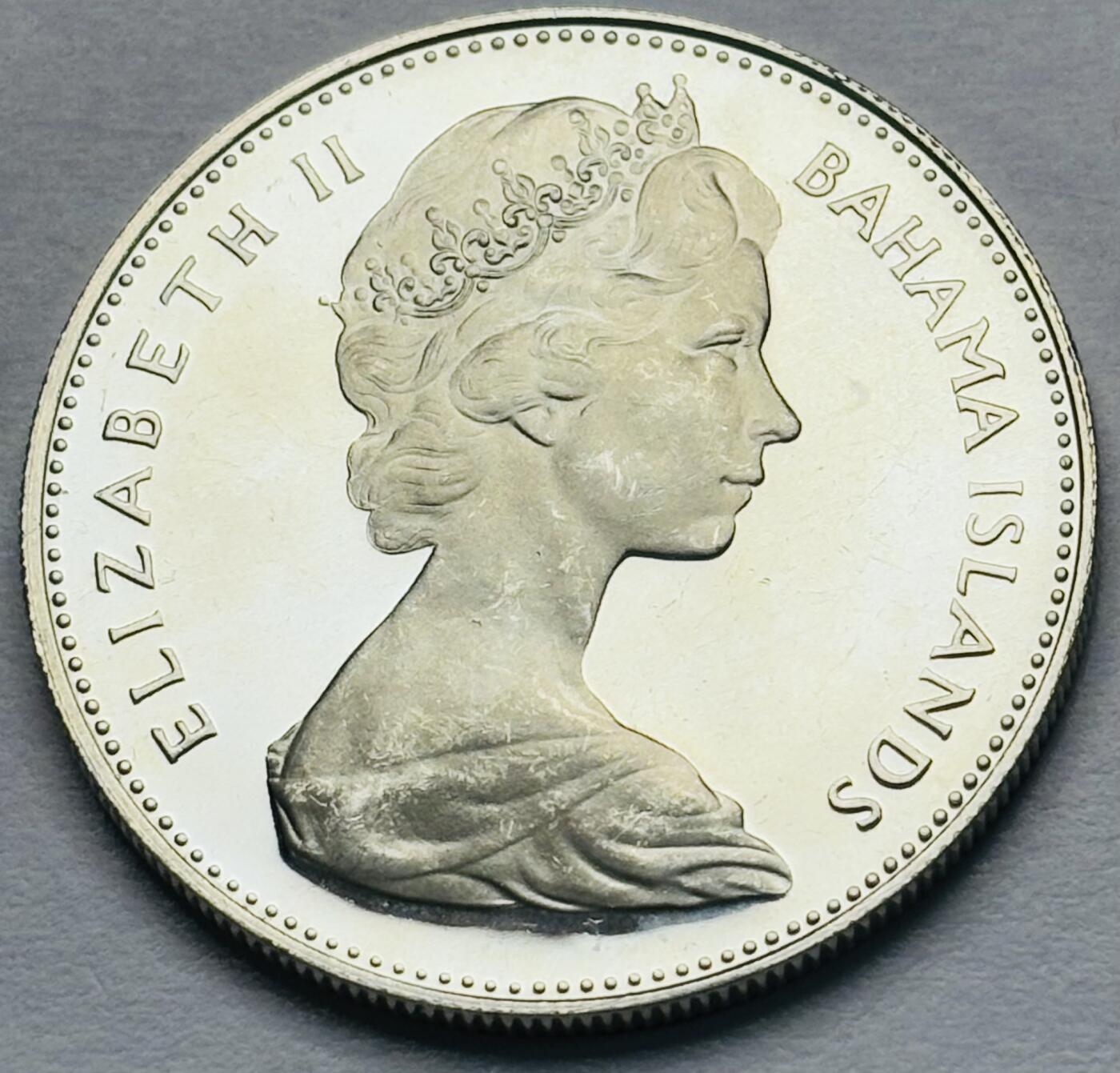 文馨钱币收藏第 283 场，【大雪鉴珍，寒英缀金】金银纪念币精品场，诚邀您的参与【长期接代拍品】 原光品相 1970 年巴哈马一元精制银币，少见第一版关门版 18.14 克 800 高银