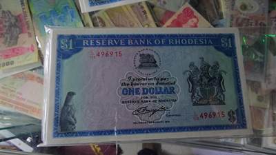 世界钱币～微拍第218期暨2025年第58期  老库存低价起拍 - 1979年罗德西亚1元 全新绝品尾号915