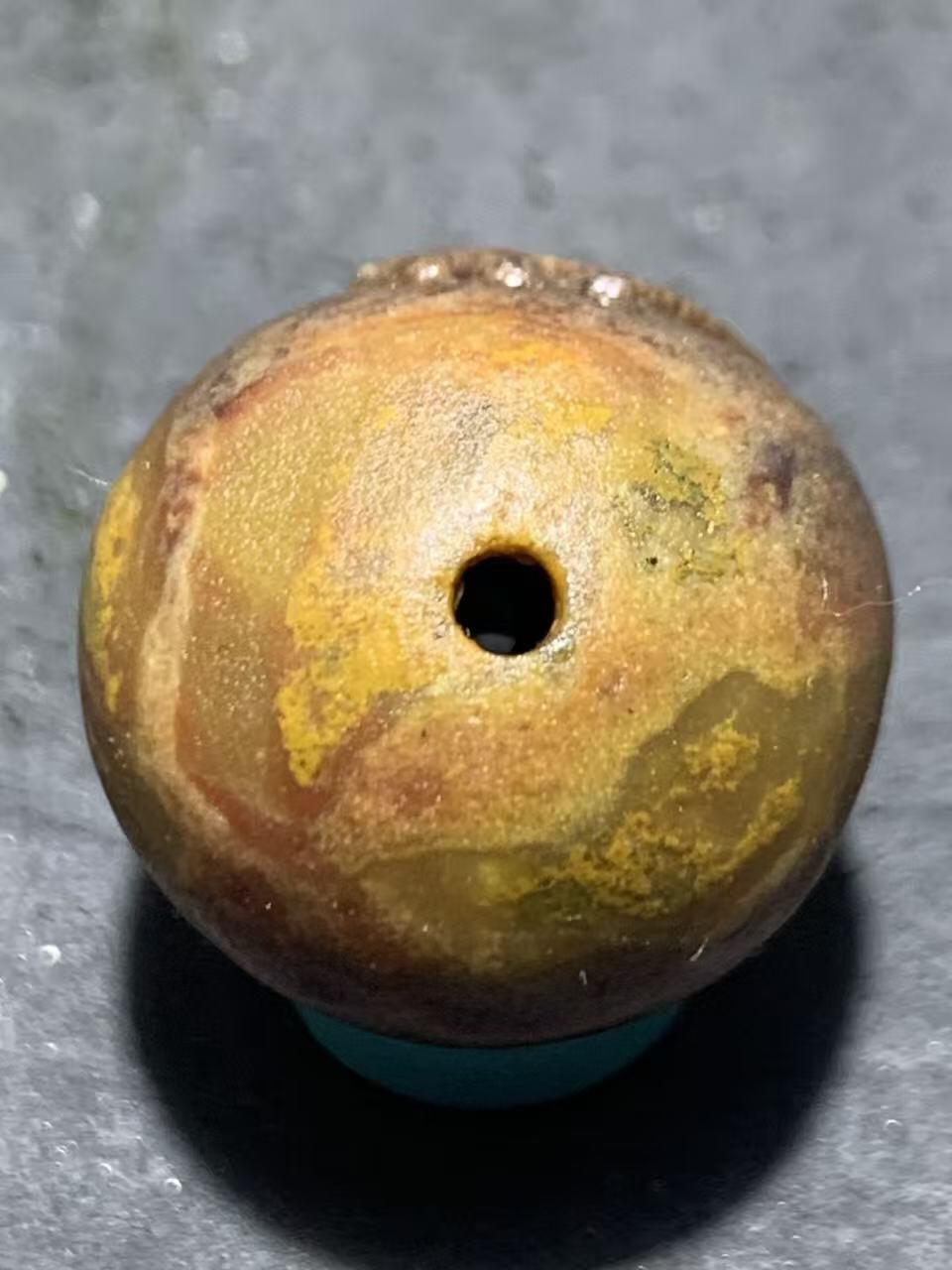 亚光战国红玛瑙手工雕刻佛字随形圆珠一颗