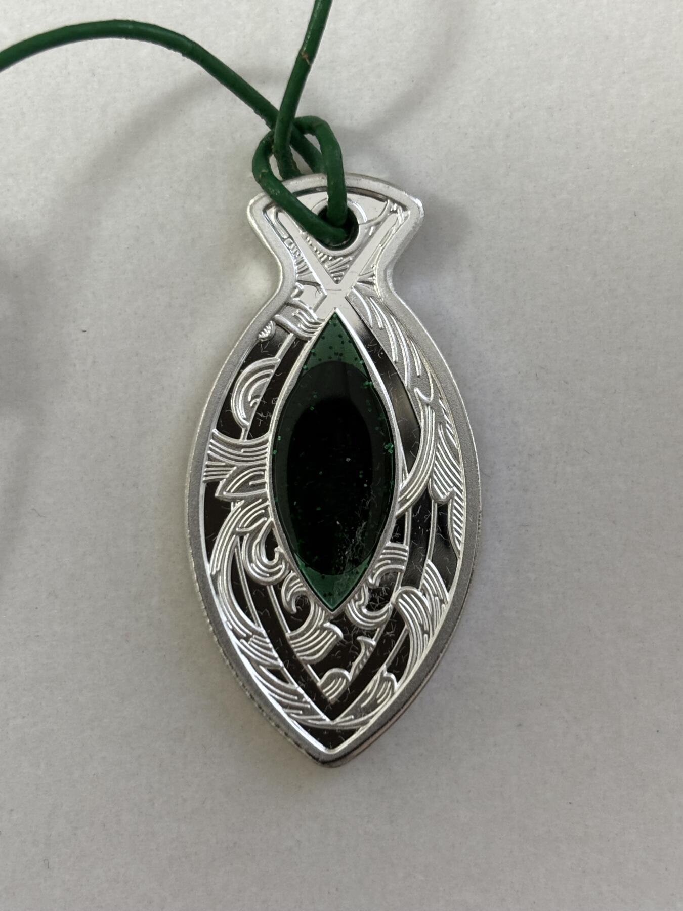 第184期拍卖 纽埃2022年鱼形吊坠镶嵌荧光石异形纪念银币，16.2克，发行量500枚