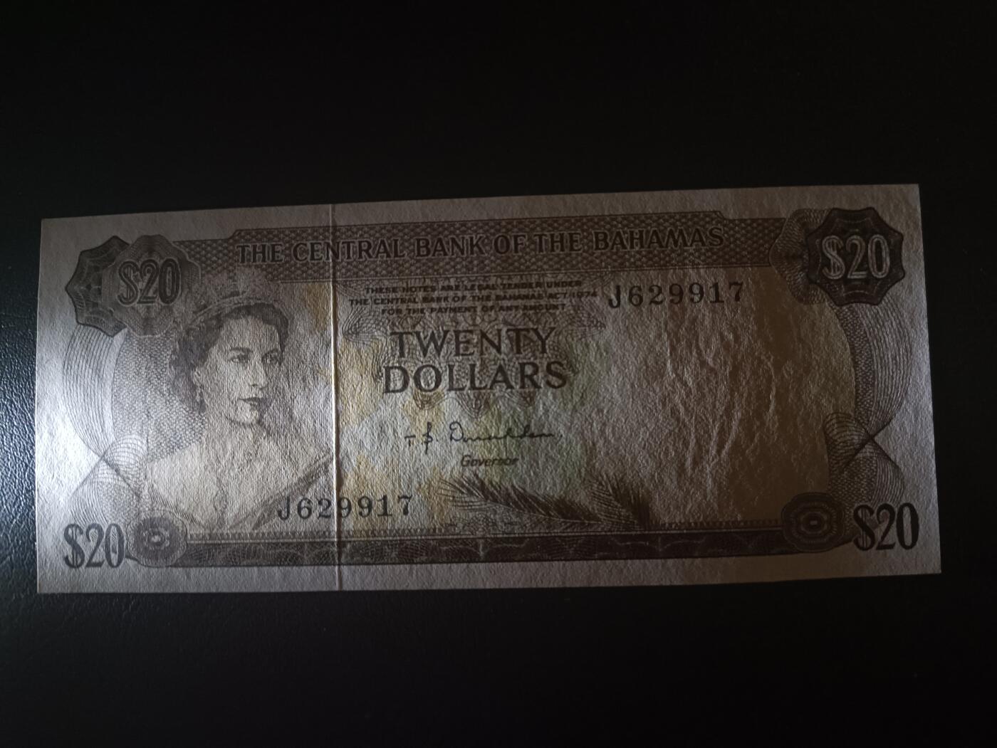 2025十二月第一期，总206期 巴哈马1974版20元UNC-，后期“巴哈马中央银行”抬头，稀有的中高面值，大冠女王和传统观光马车，德纳罗公司水粉画风格的唯美彩背