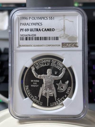 第185期拍卖 - 获奖美国1996年亚特兰大残奥轮椅赛银币NGC-PF69，900银，26.72克，此币荣获世界硬币大奖赛"最富激情币"大奖！