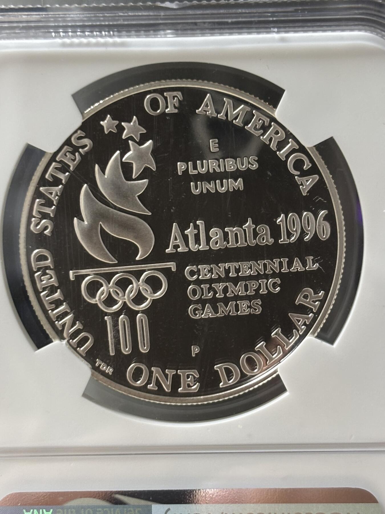 第185期拍卖 获奖美国1996年亚特兰大残奥轮椅赛银币NGC-PF69，900银，26.72克，此币荣获世界硬币大奖赛