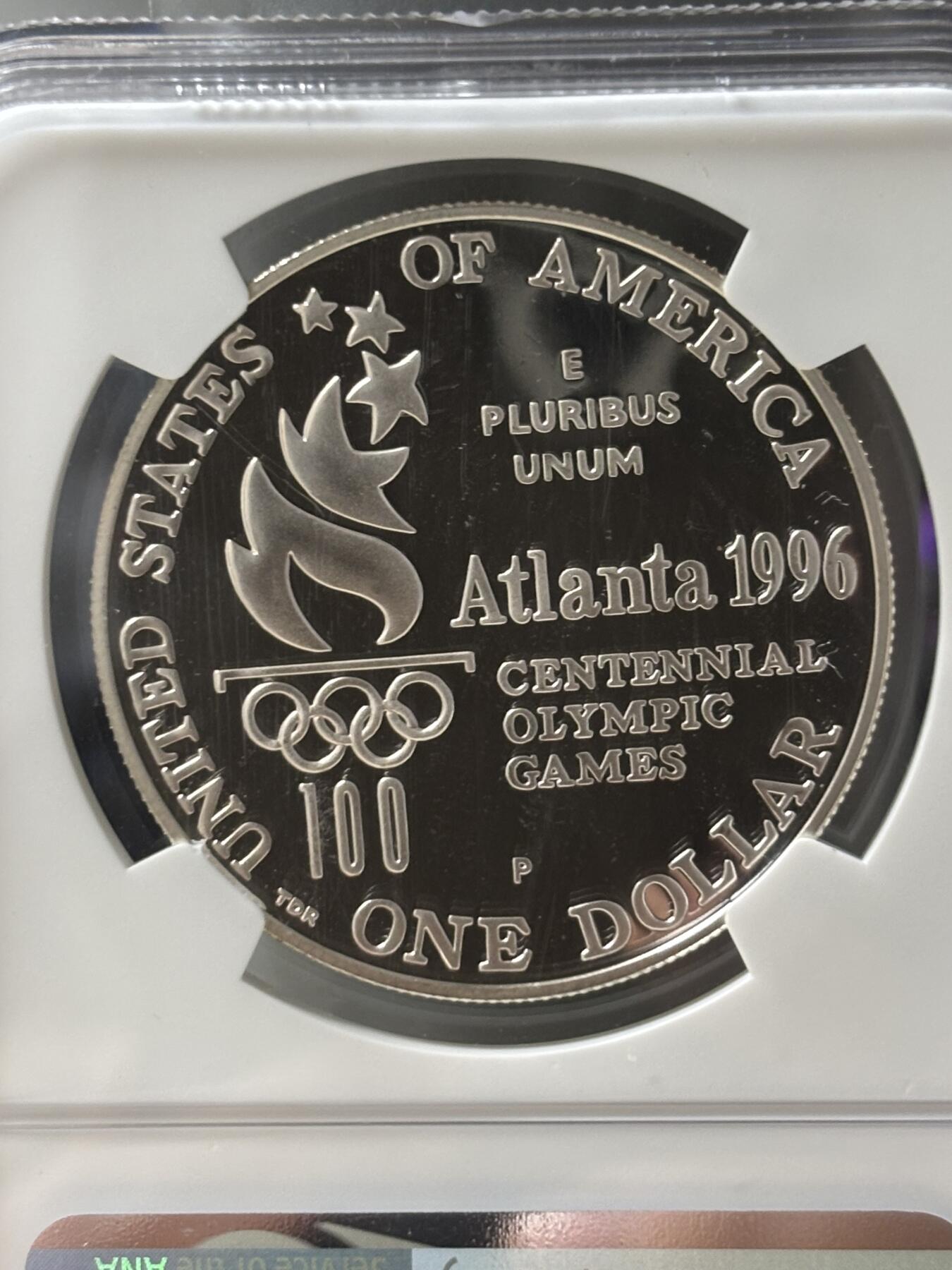 第185期拍卖 获奖美国1996年亚特兰大残奥轮椅赛银币NGC-PF69，900银，26.72克，此币荣获世界硬币大奖赛