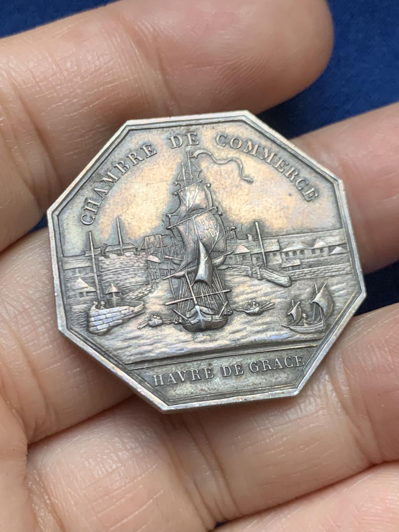 《竞宝斋》第446场 周日，周一，2场连拍 （全场包邮） 法国1958年勒阿弗尔商会八角银质代币 19.3克 32mm 丰饶角1银标  正面：十八世纪勒阿弗尔港全景，停泊着多艘帆船； 背面：锚形图案标注年份「1802-1958」，火焰中小火龙图案，中央为商会大楼景观；下方设计师签名「M·德尔努瓦」