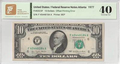 2025十二月第二期，总207期 - 美国1977年10元TQG40分，由于背面油墨折叠失误造成了一种有趣的“背面错滚墨”错版
