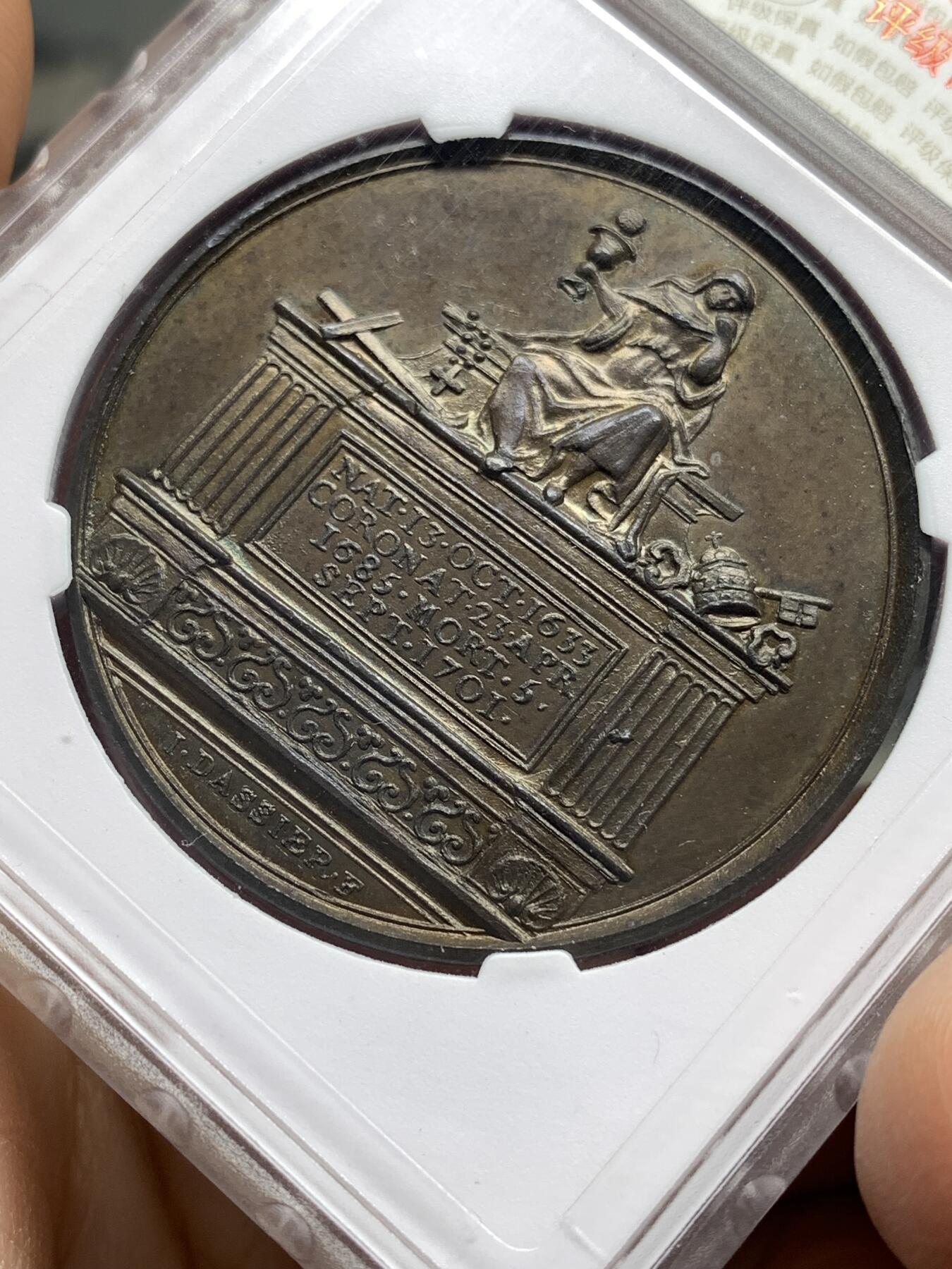 《竞宝斋》第446场 周日，周一，2场连拍 （全场包邮） 华夏 MS62 英王詹姆斯二世纪念铜章，英国历代君主纪念铜章系列之斯图亚特王朝末代国王詹姆斯二世，目录编号：Eimer 384。著名雕模大师瑞士人Dassier的作品，此版属于在整个英王系列里很受欢迎的热门国王品种。开放式盒评级，高浮雕艺术性很强，全面氧化形成“巧克力”色包浆，底板细腻光洁，呈现类精制工艺状态！