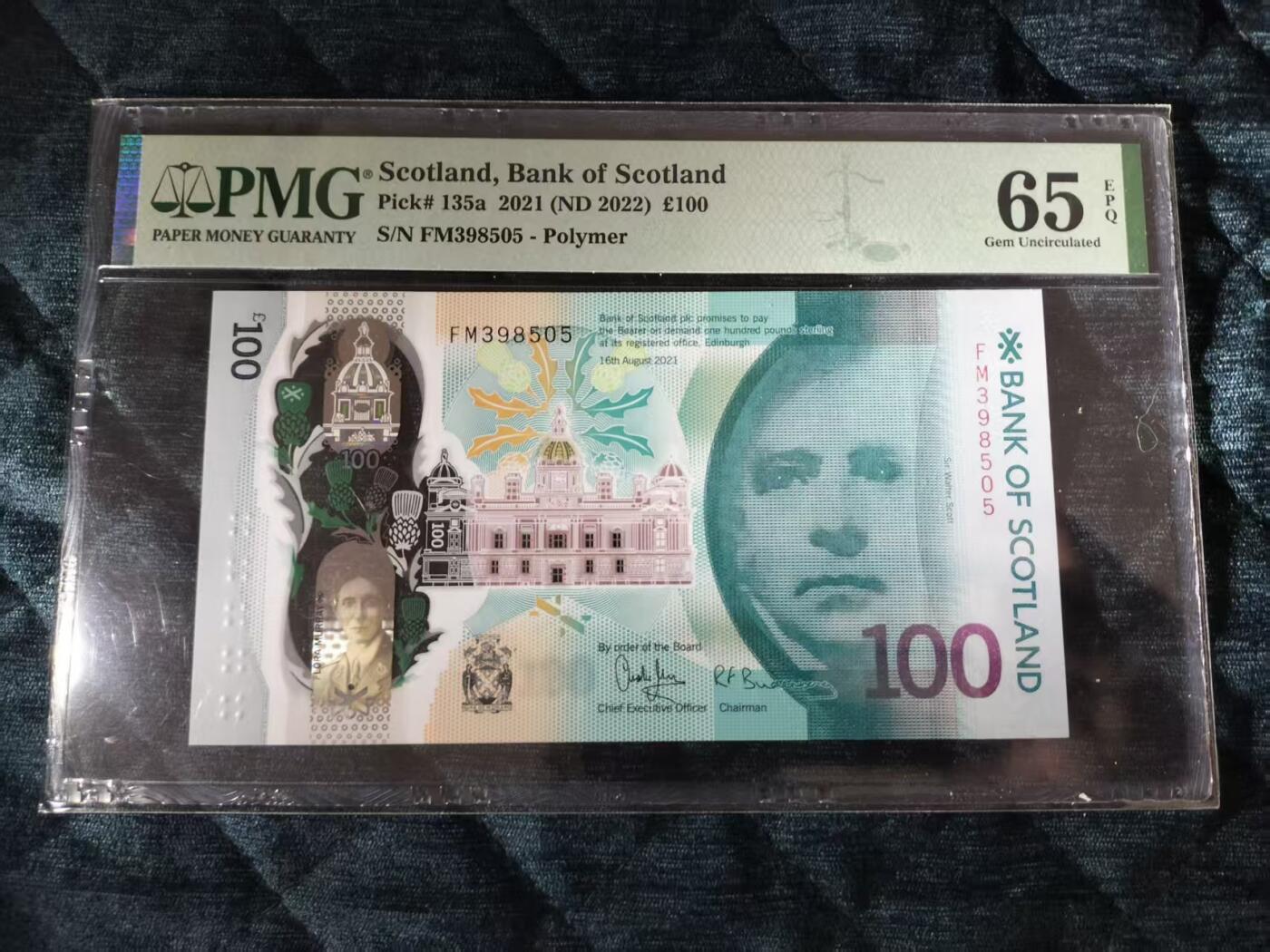 【礼羽收藏】🌏世界钱币拍卖第115期 苏格兰银行2021年100镑塑料钞，PMG评级65分，FM398505号，全新未流通，带评级壳，票面保存完好，收藏价值高。