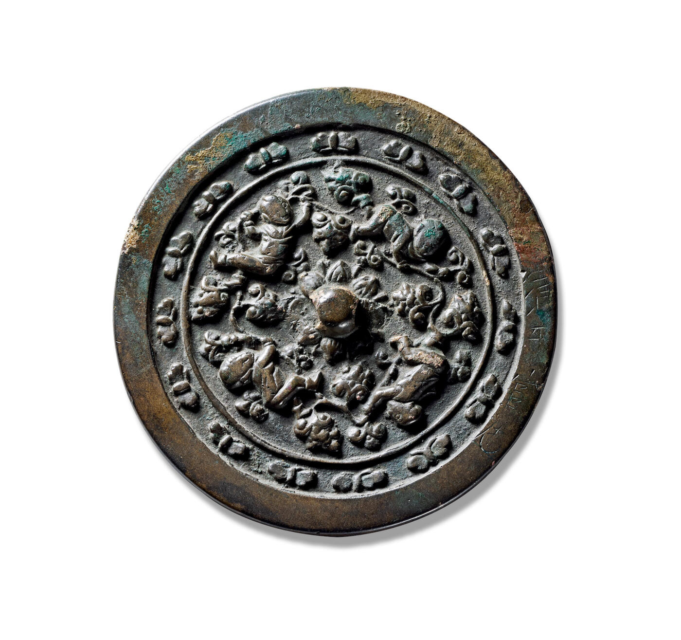 上海匡时2025年秋季拍卖会 中国历代钱币 铜镜专场 童子戏莲镜 圆形，圆钮，经典童子戏莲题材铜镜，采用高浮雕的表现技法。镜背满铺莲花花叶纹饰，刻画精细，叶脉清晰，繁郁葱茂，莲花纹上铸饰四位童子形象面目清晰，稚嫩可爱，身着童衣，形态各异，趴伏嬉戏，极富趣味。镜背呈现出一副极具生活气息的婴戏图景，“婴戏”题材为这一时期较为经典的一个艺术主题，且应用颇广，最早即被具有独特艺术气息的文人雅士所捕捉并运用在绘画艺术上，体现了对孩童的无限关爱与期望，又表达了古