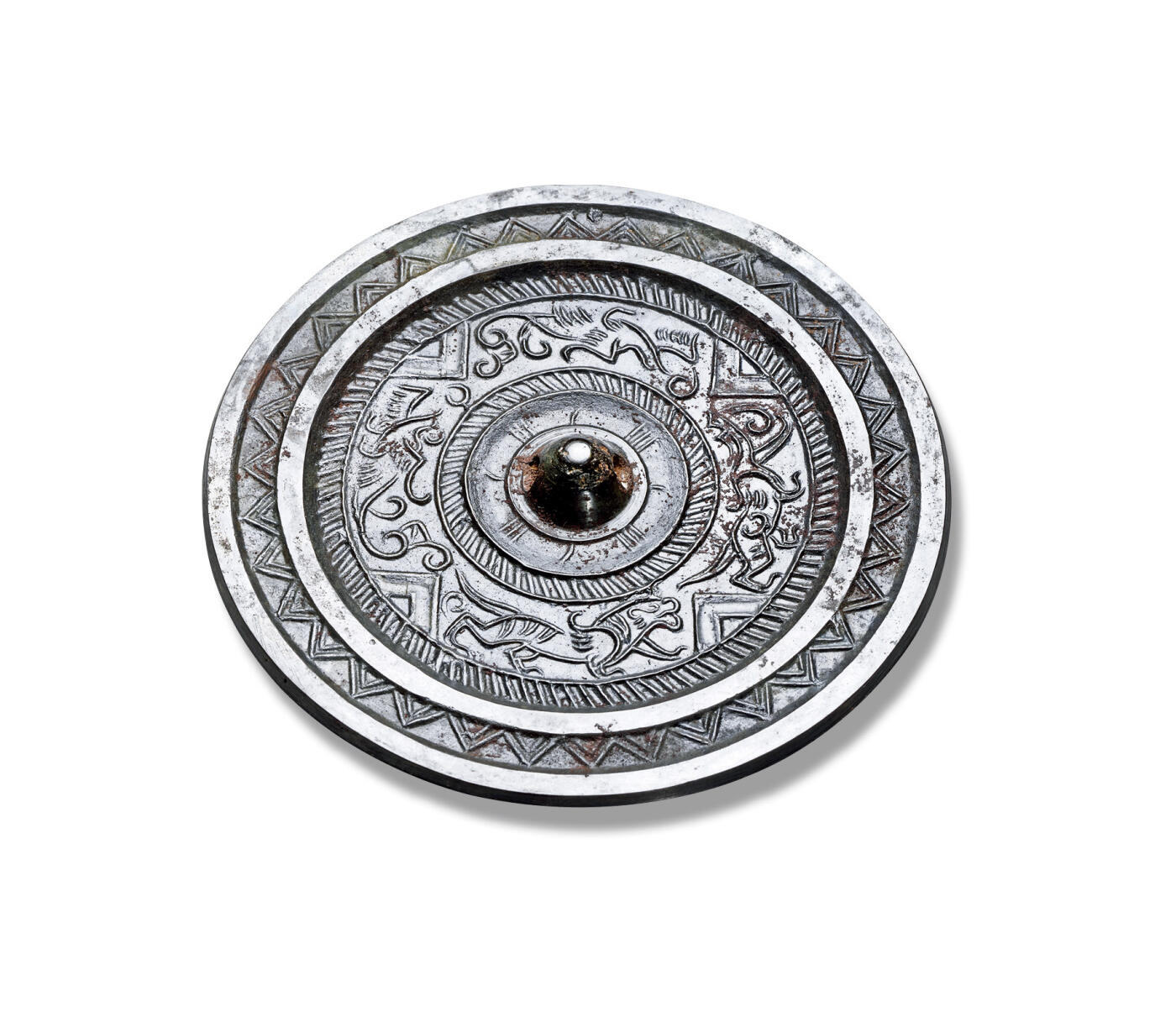 上海匡时2025年秋季拍卖会 中国历代钱币 铜镜专场 瑞兽简化规矩镜 圆形，圆钮。纹饰布局精美，神兽分饰四方，以L形纹为界。神兽造型灵动自然，线条流畅。镜体包浆细润，皮壳温净。