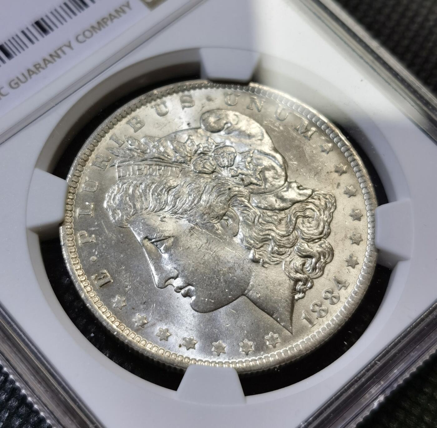 甄臻铺-世界币章拍卖（第43期）送拍享返佣金等优惠多多 NGC-MS64 1884年O版摩根，币面干净