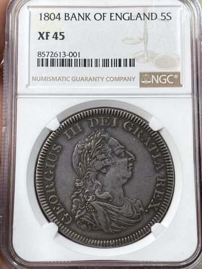 万国钱币拍卖第057期（万国冬季大拍） - NGC XF45 1804年英国乔治三世英格兰银行5先令大银币 由于当时英国白银短缺 直接压印在西班牙双柱之上的品种 双柱影子依稀可见 原味黑彩好状态