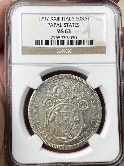 万国钱币拍卖第057期（万国冬季大拍） - NGC MS63 意大利教皇国1797年60Baiocchi银币，教皇庇护六世时期发行。讨人喜欢的教皇国小牧徽，一个人正在对着植物吐口水，设计非常奇特。NGC老盒严评，该年份多年唯一冠军。实物状态极佳。