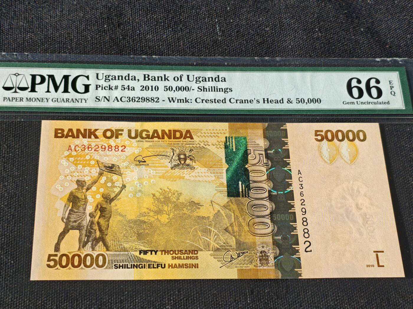 刘世昌艺术品销售中心～虎踞龙蟠*金杨在线联拍群第512期 乌干达2010年5万先令（PMG    66E    号码：AC3629882）1枚。此币荣获当年IBNS“世界最佳纸币”大奖。