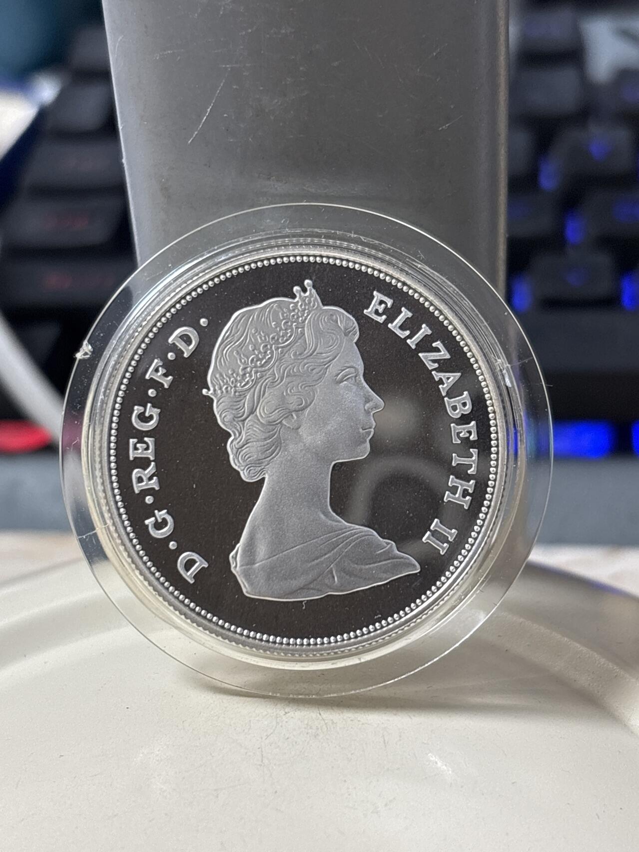 第185期拍卖 英国 1980年  女王母亲80岁生日25便士精制克朗银币原盒证书。925银 28.07克 发行量：25万枚 币有氧化，【银价374】